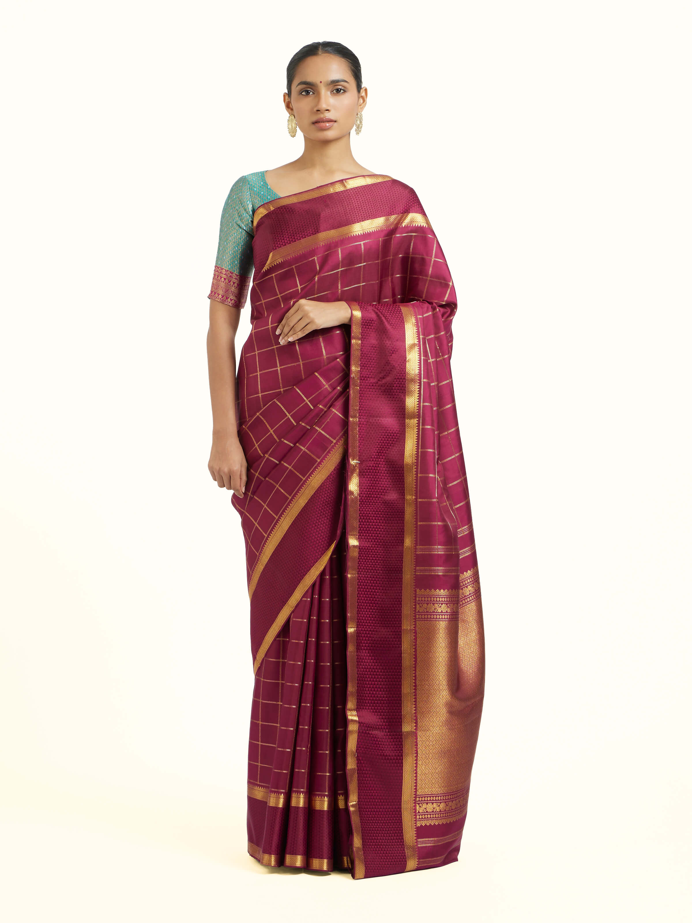 Front view of burgundy silk Kancheepuram saree with rich zari motifs
