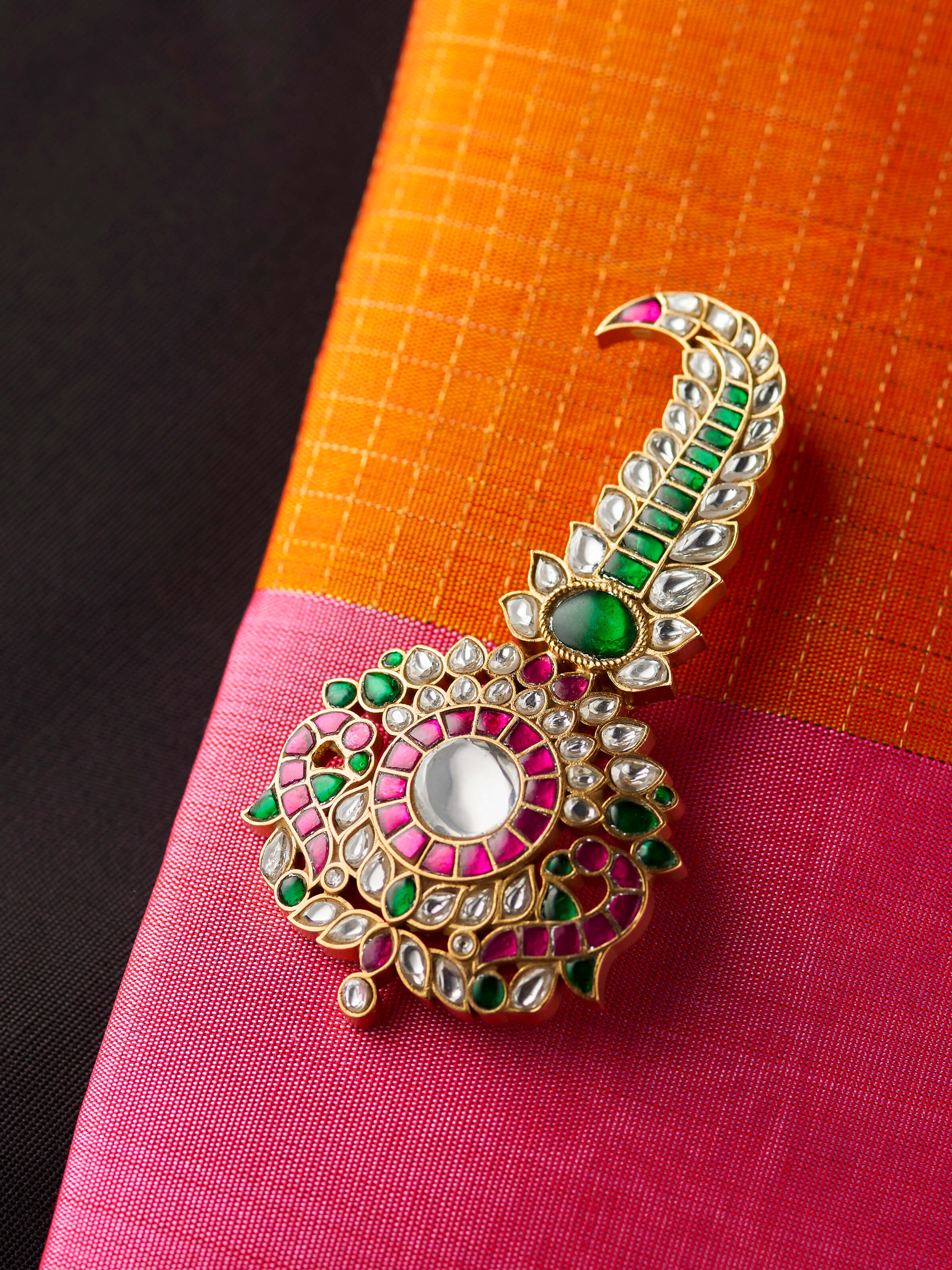 detail view of silver smithing yellow gold brooch pin pattern