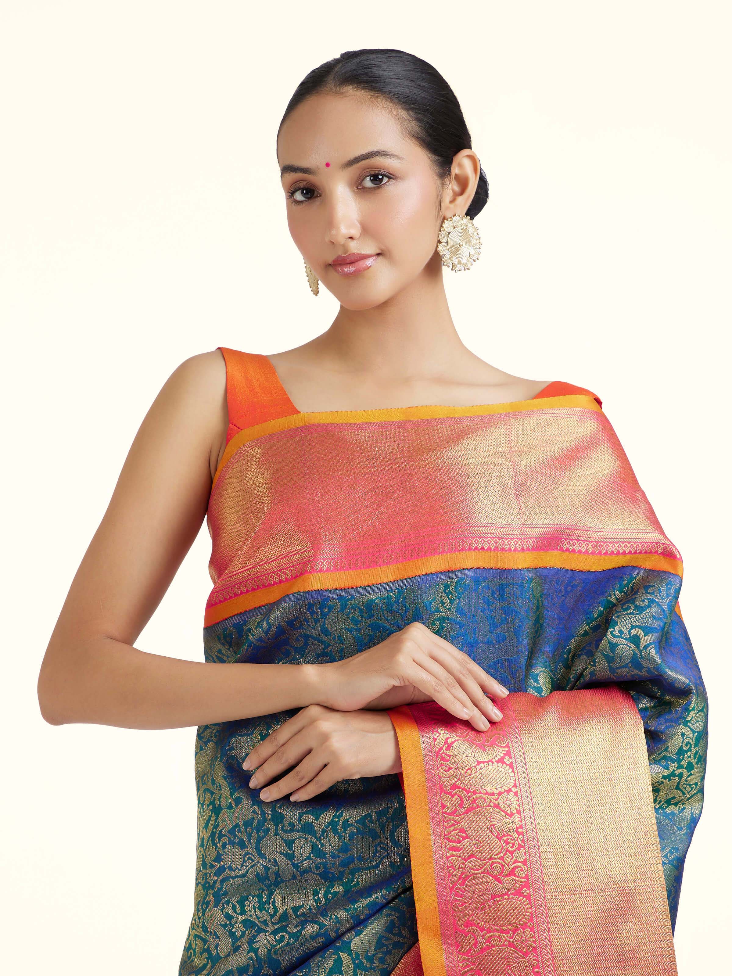 Angled view of blue silk Kancheepuram saree highlighting traditional weave and sheen