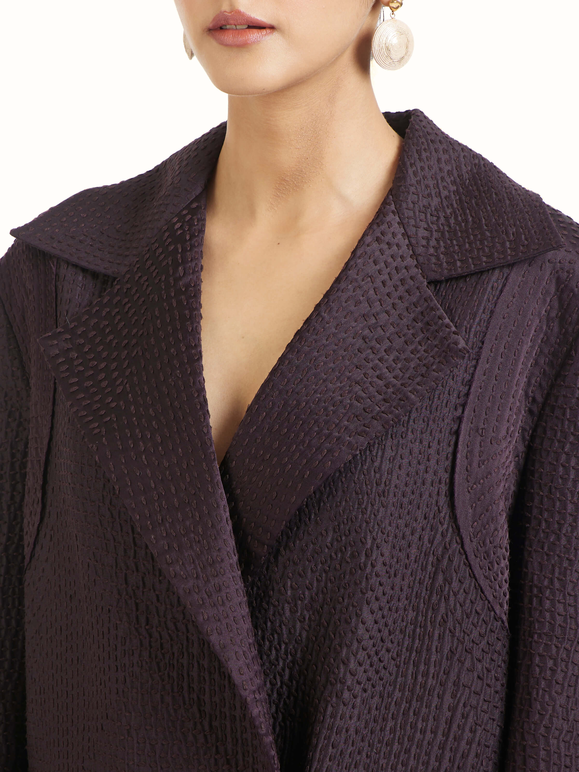 Detail view of purple silk kantha trench coat showing fabric texture and kantha embroidery