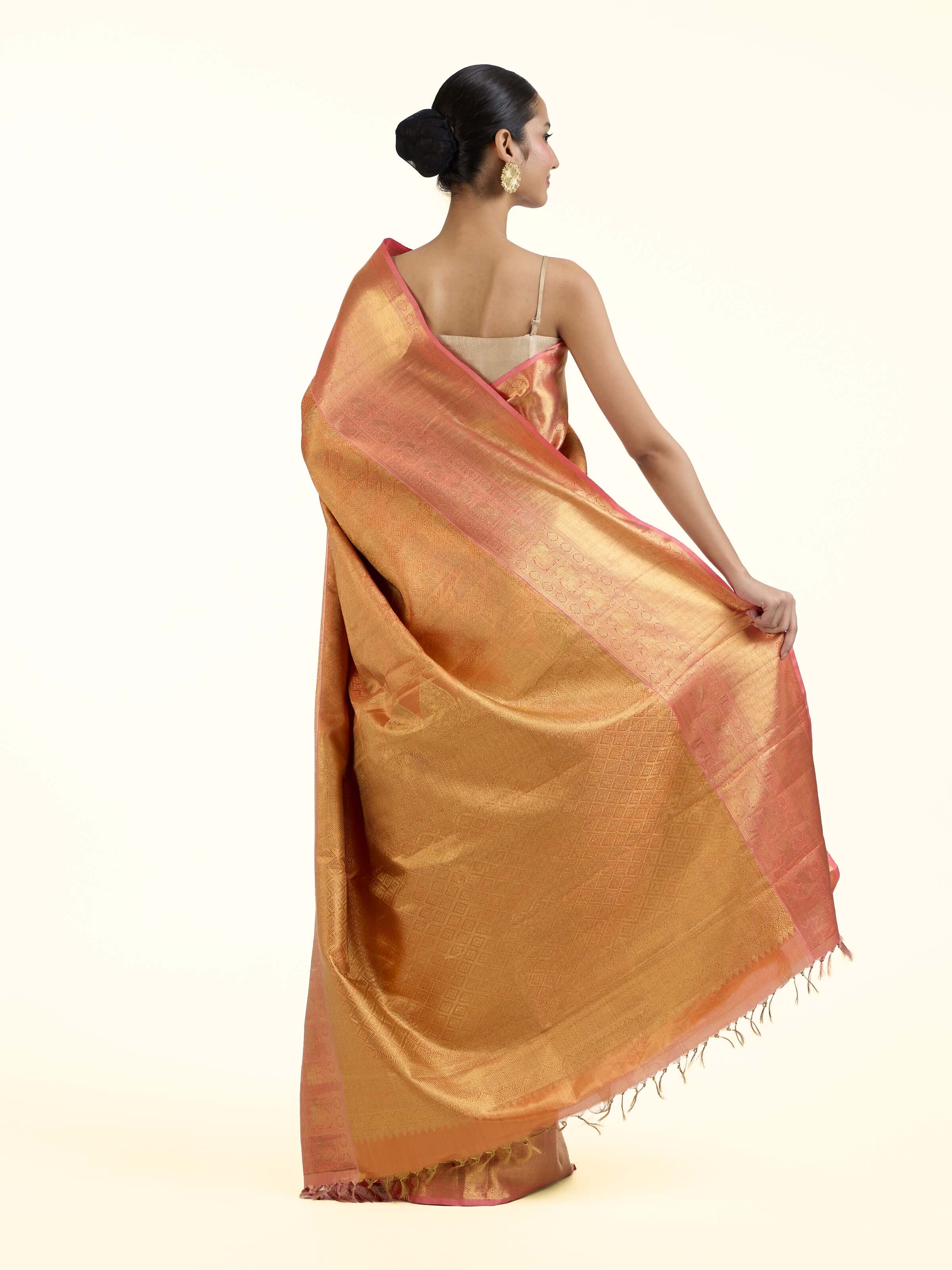 Back view of yellow silk Kancheepuram saree displaying ornate pallu design