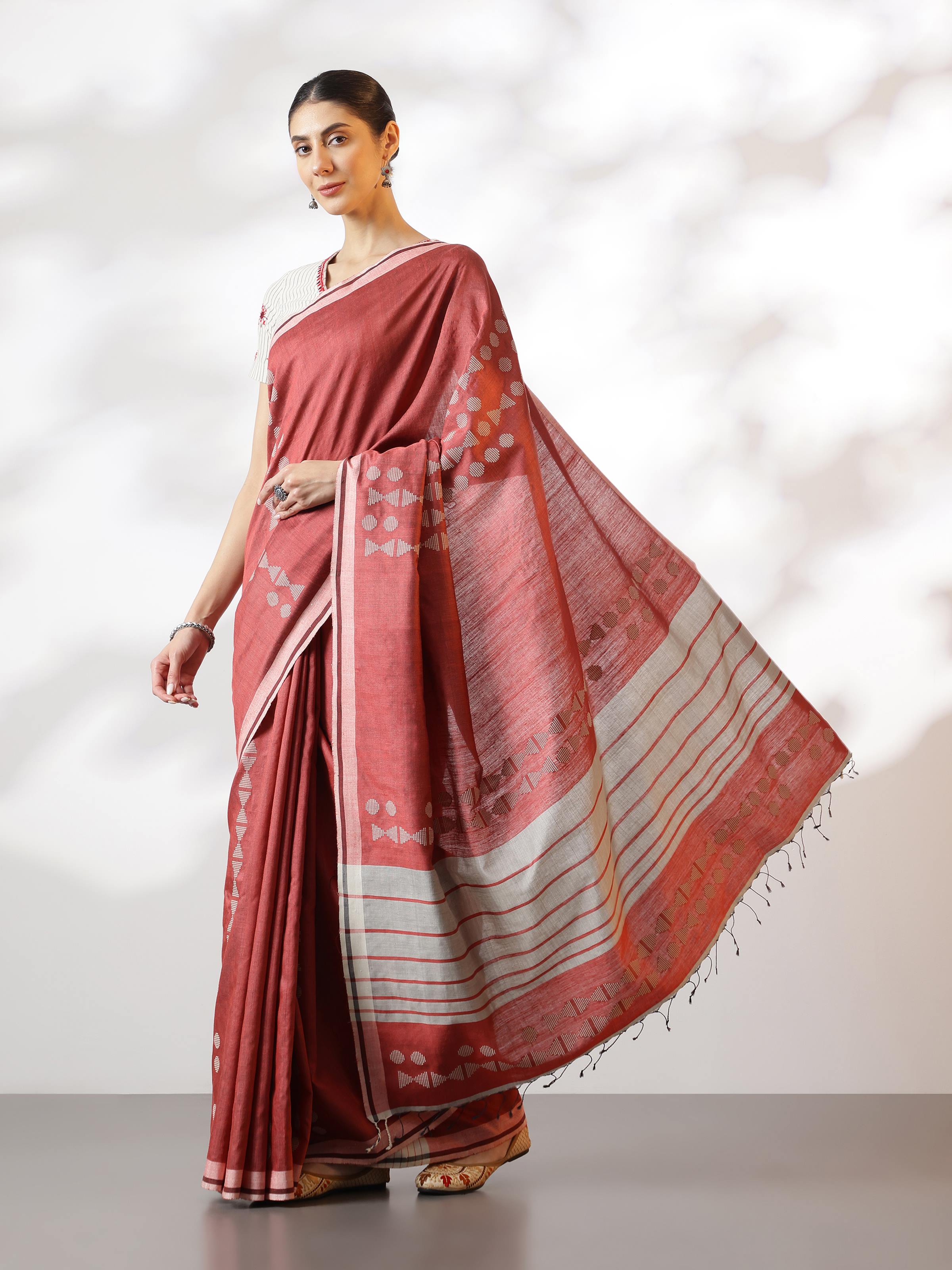 Lifestyle view of Maroon Silk Extra-weft Saree worn by model emphasizing smooth silk texture and graceful drape.