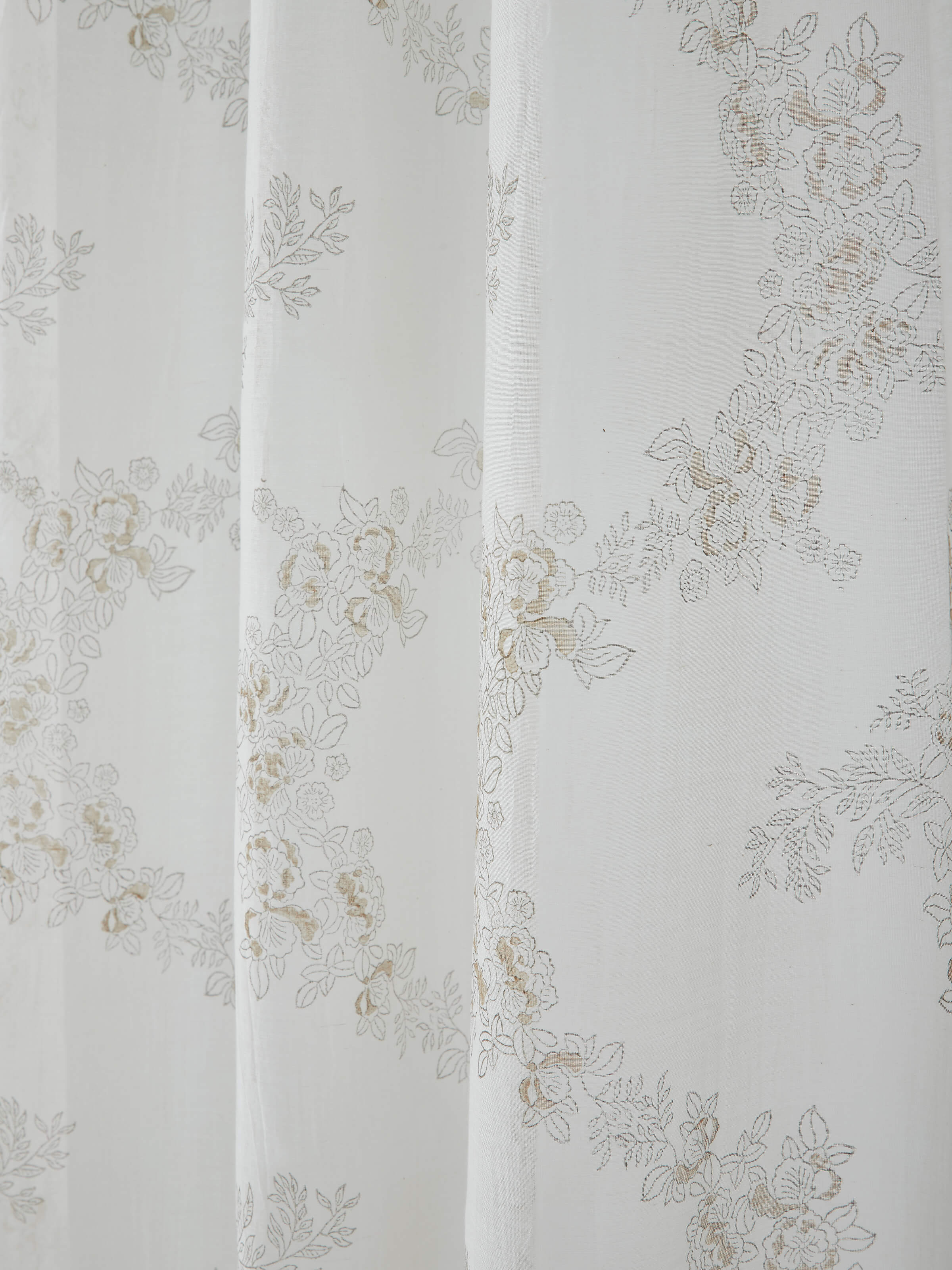 Angled view of Shivranjini Block Printed Curtain, capturing the interplay of ivory base with elegant blue print.