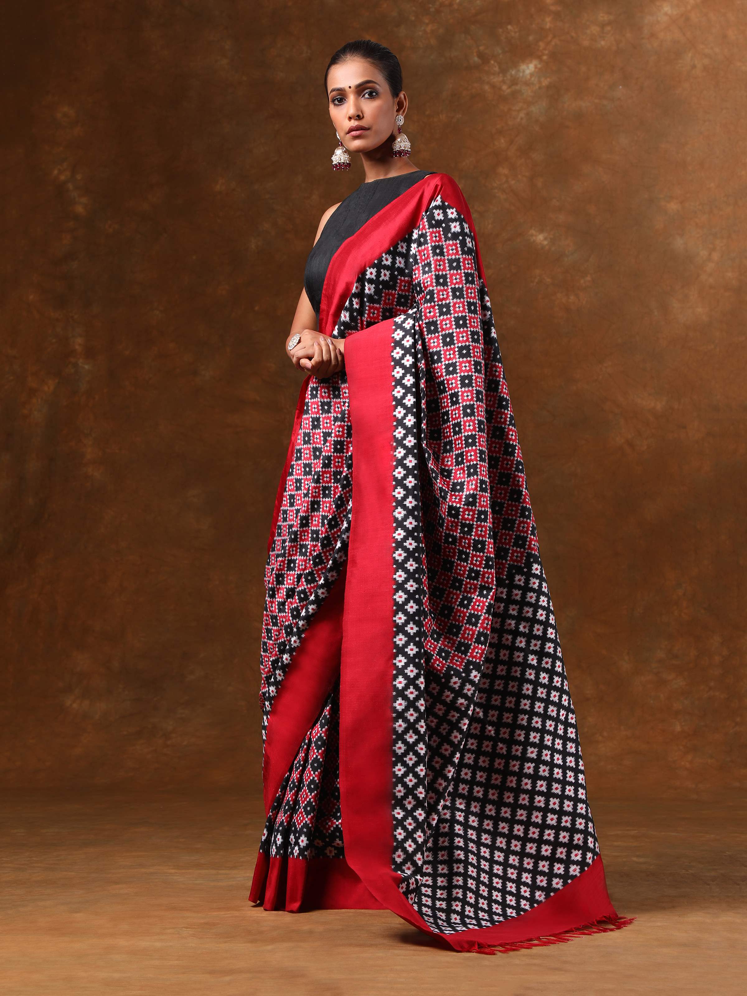 Lifestyle view of black Telia Rumal Ikat saree styled with contrast blouse