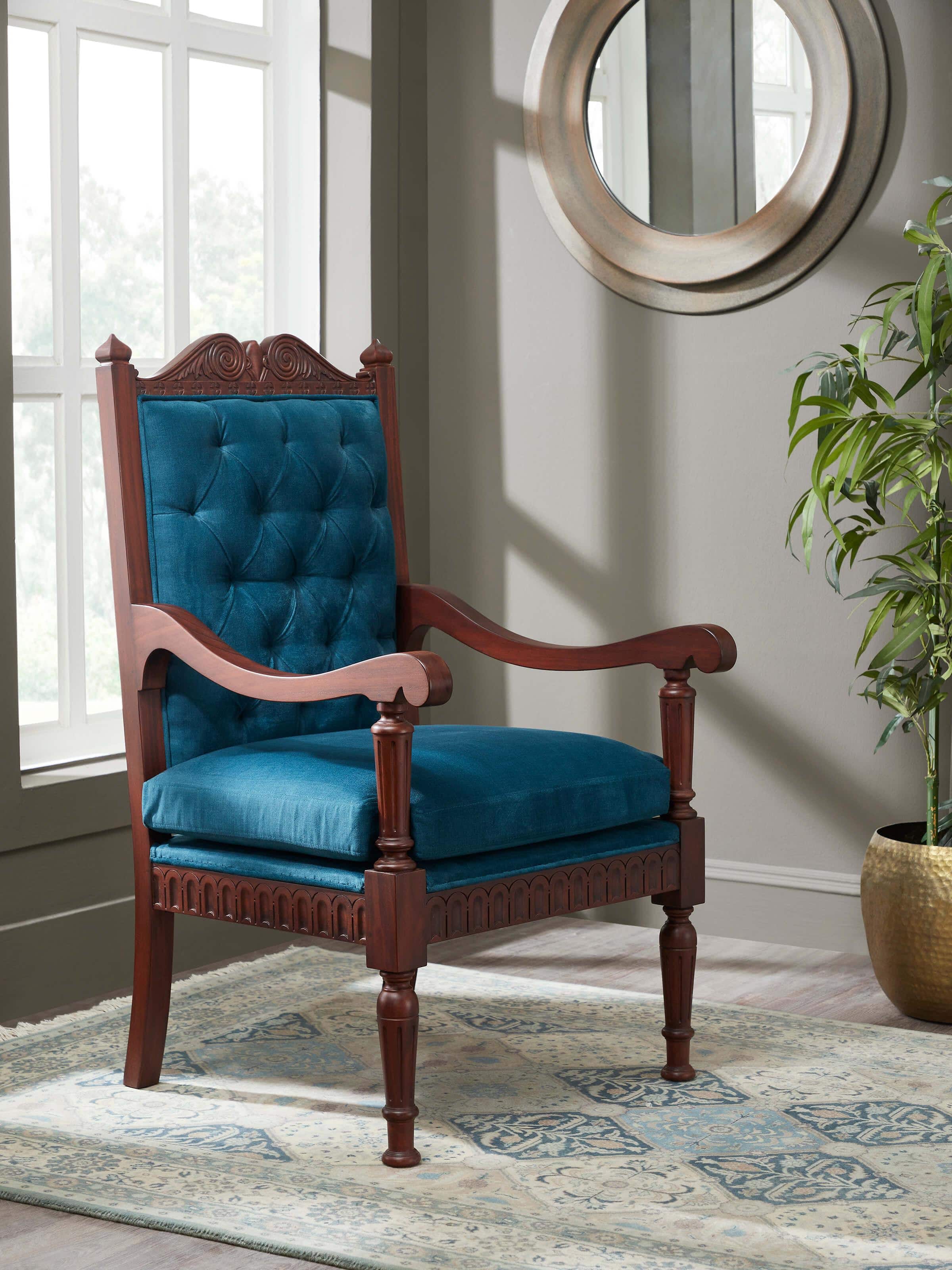 Lifestyle view of upholstered mahogany wood arm chair placed in an elegant room setting