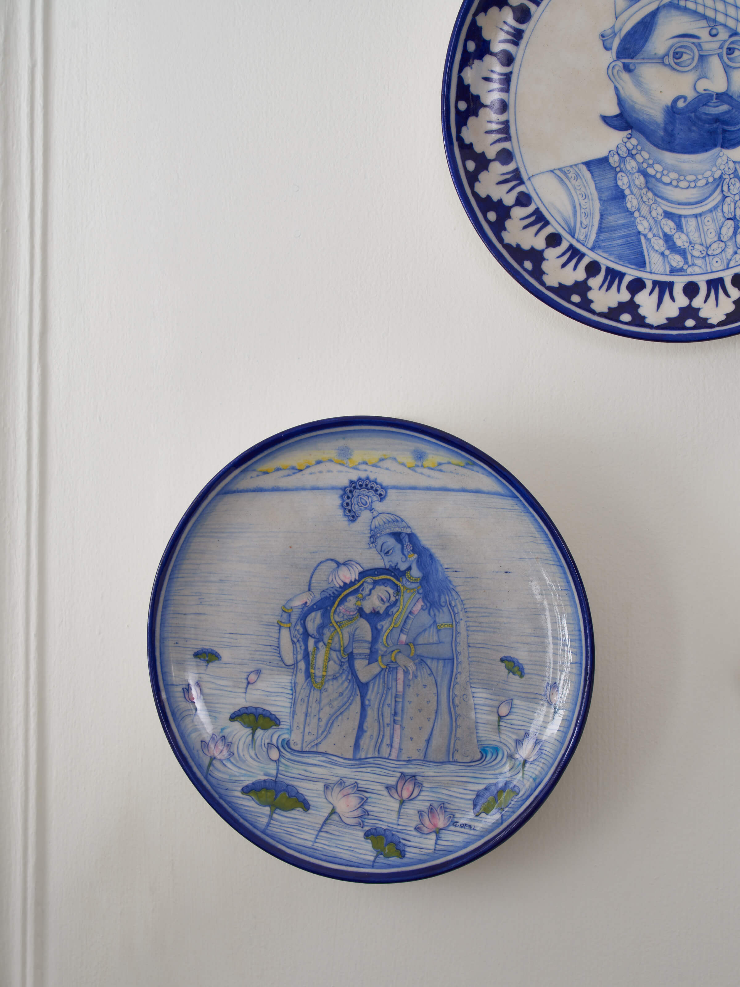 Angled view of Blue Pottery Lovers Display Plate, focusing on the fine details and vibrant colors of the design.