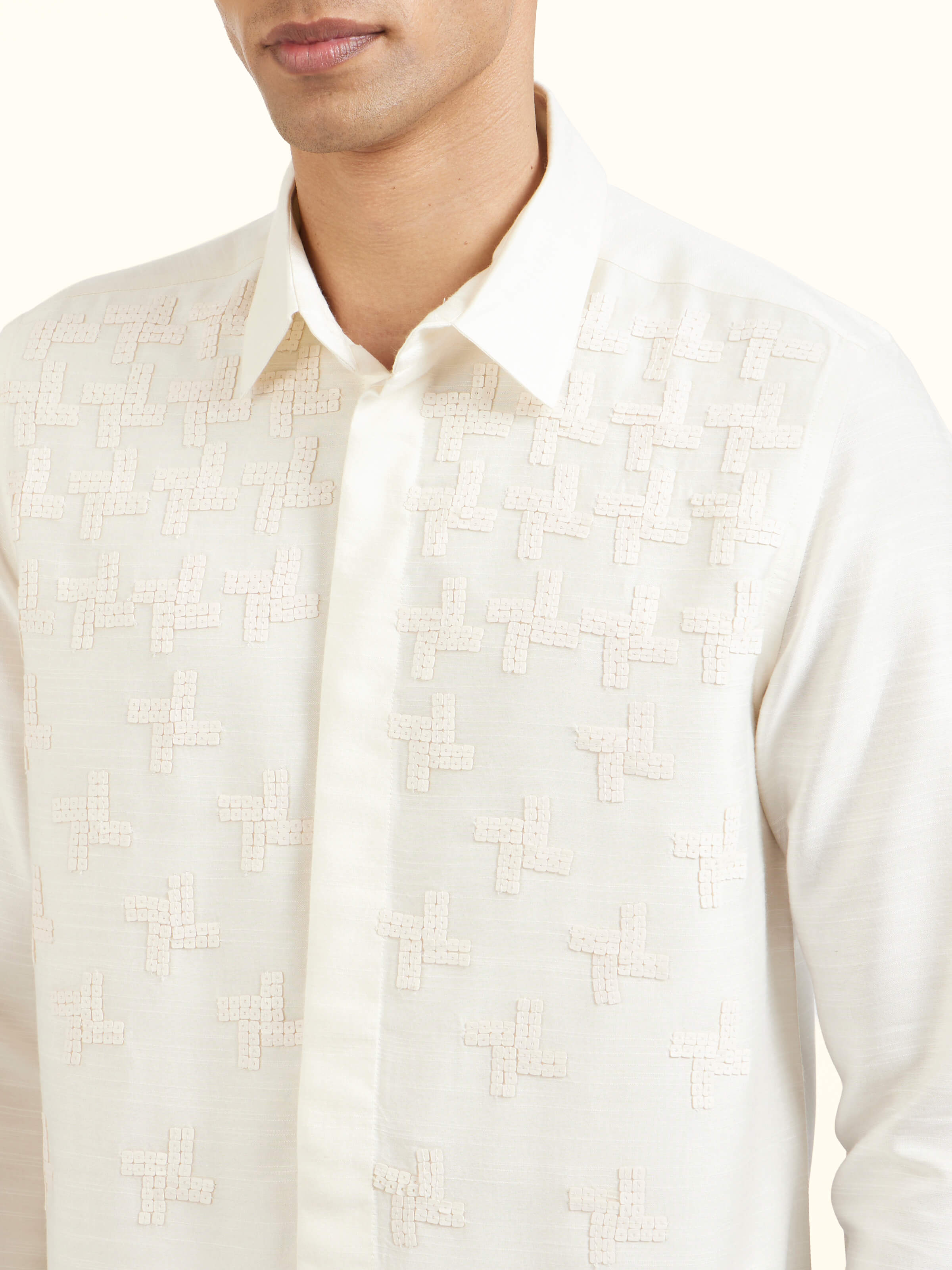 Detail view of white hand embroidery shirt showing fine stitching and handworked details