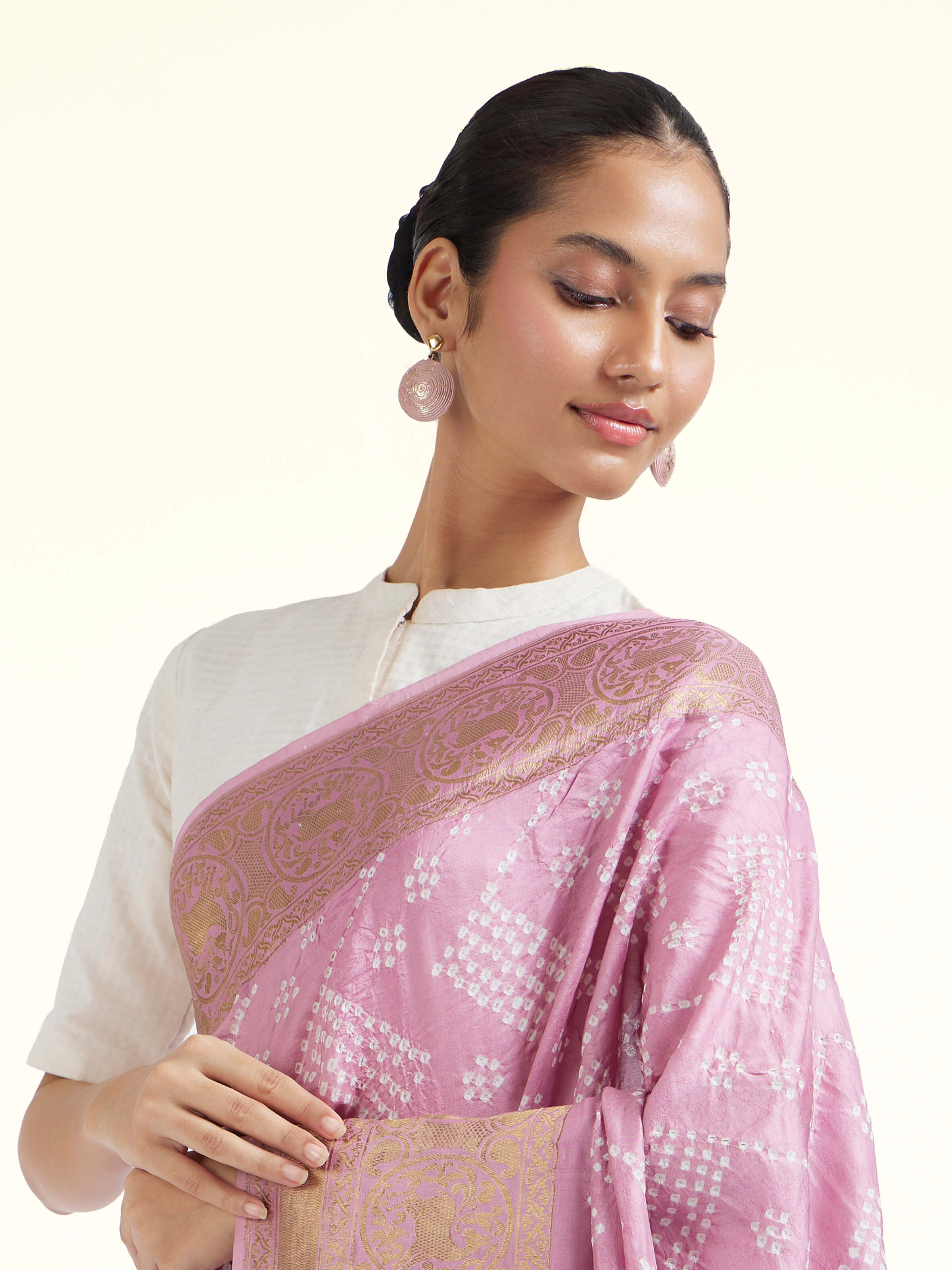 Angled view of lavender silk tie and dye Bandhani saree emphasizing hand-dyed texture