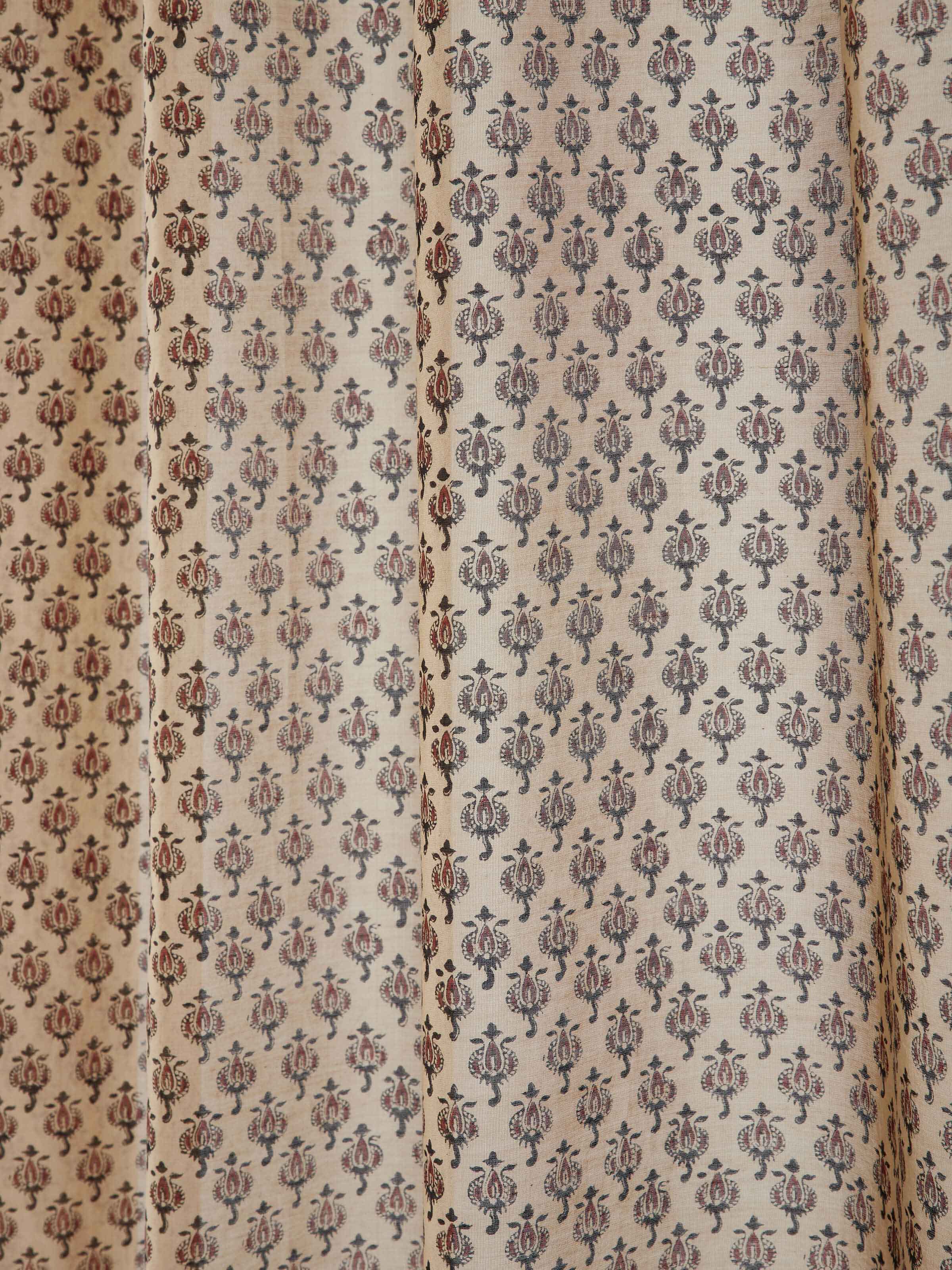 Detail showing cotton silk weave and block printed buti in rust shade.