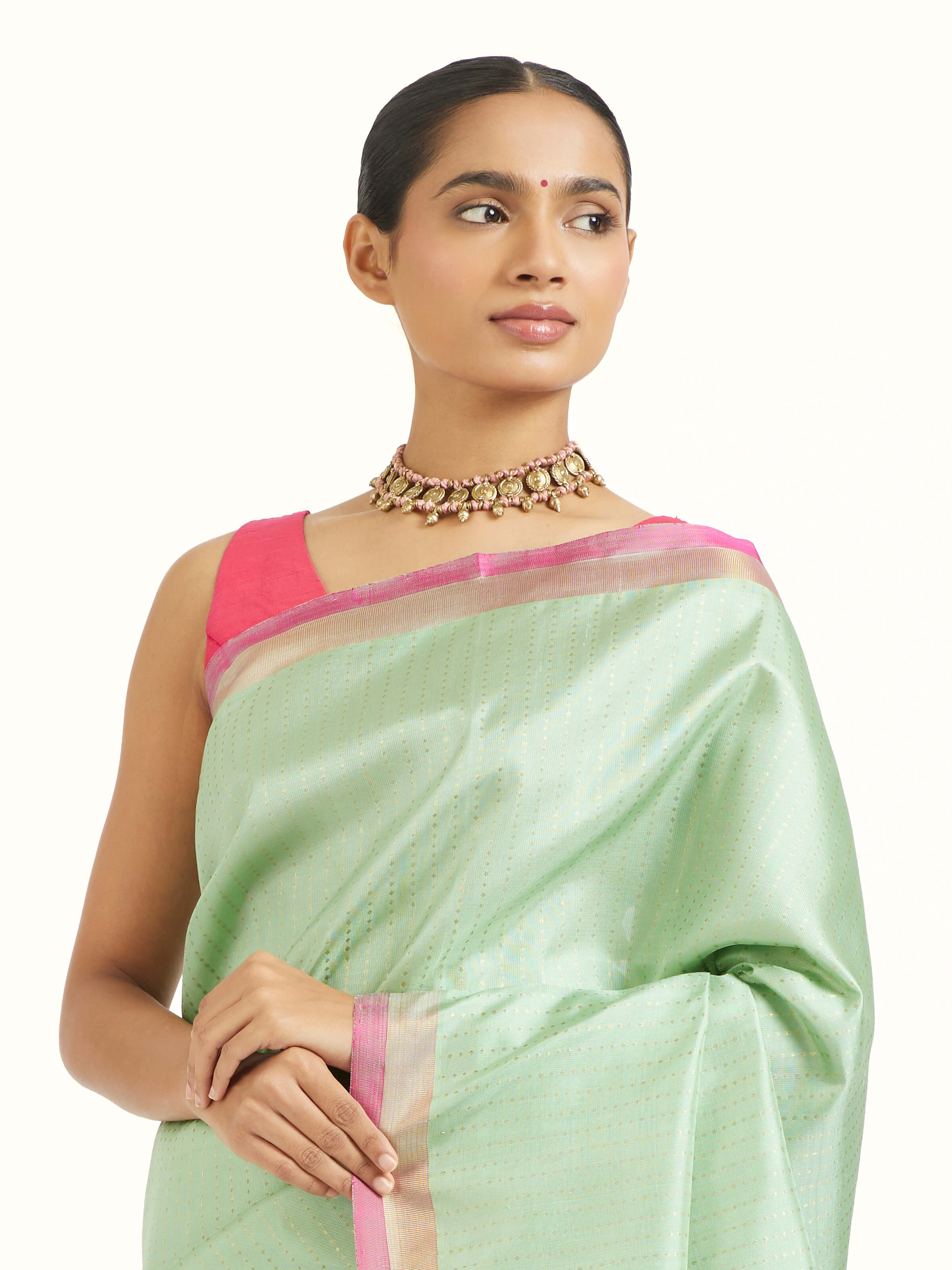 Angled view of light green silk Kancheepuram saree highlighting lustrous weave