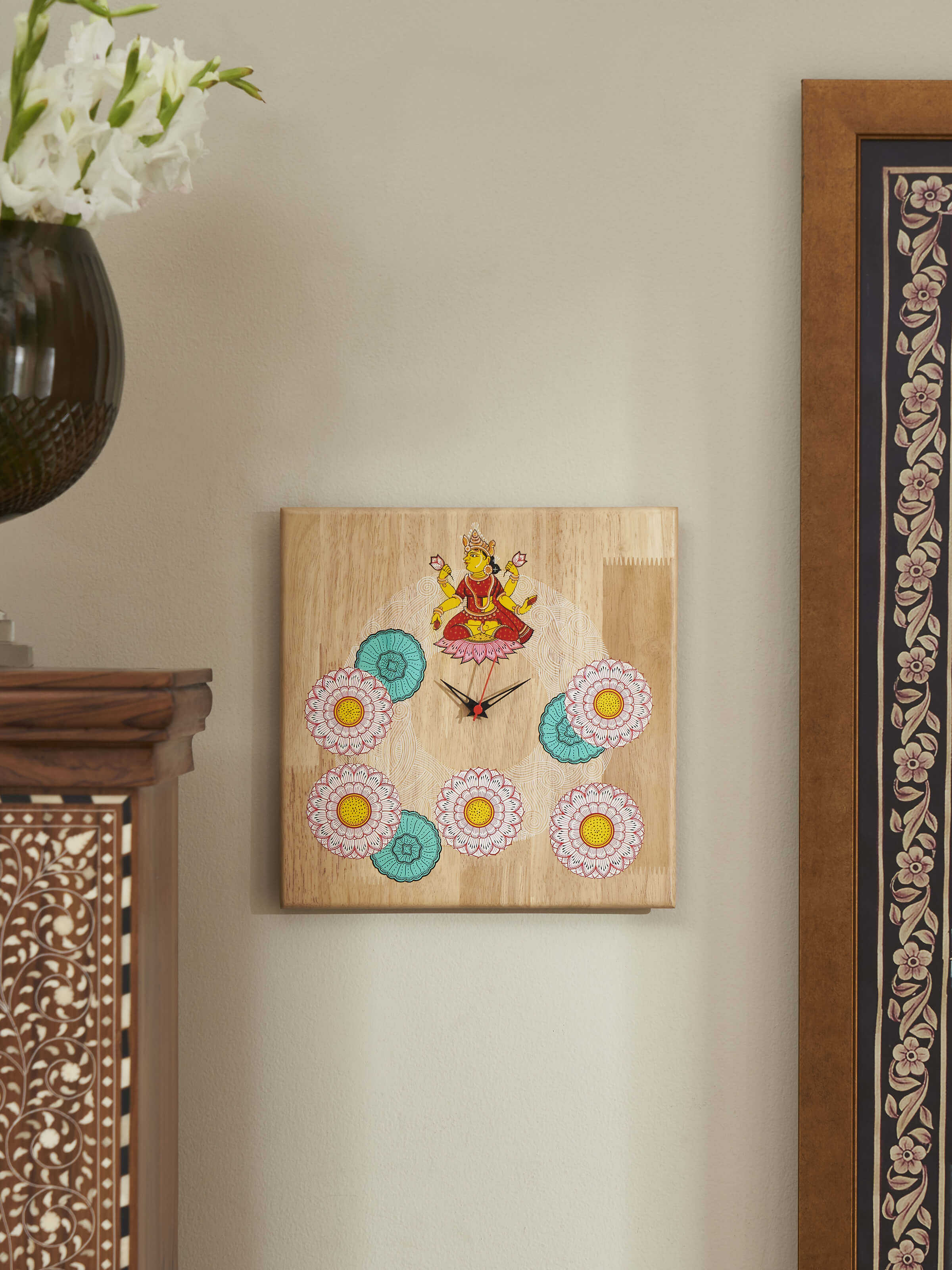 Lifestyle view of painted Pattachitra Lakshmi wooden wall clock ethnic home decor