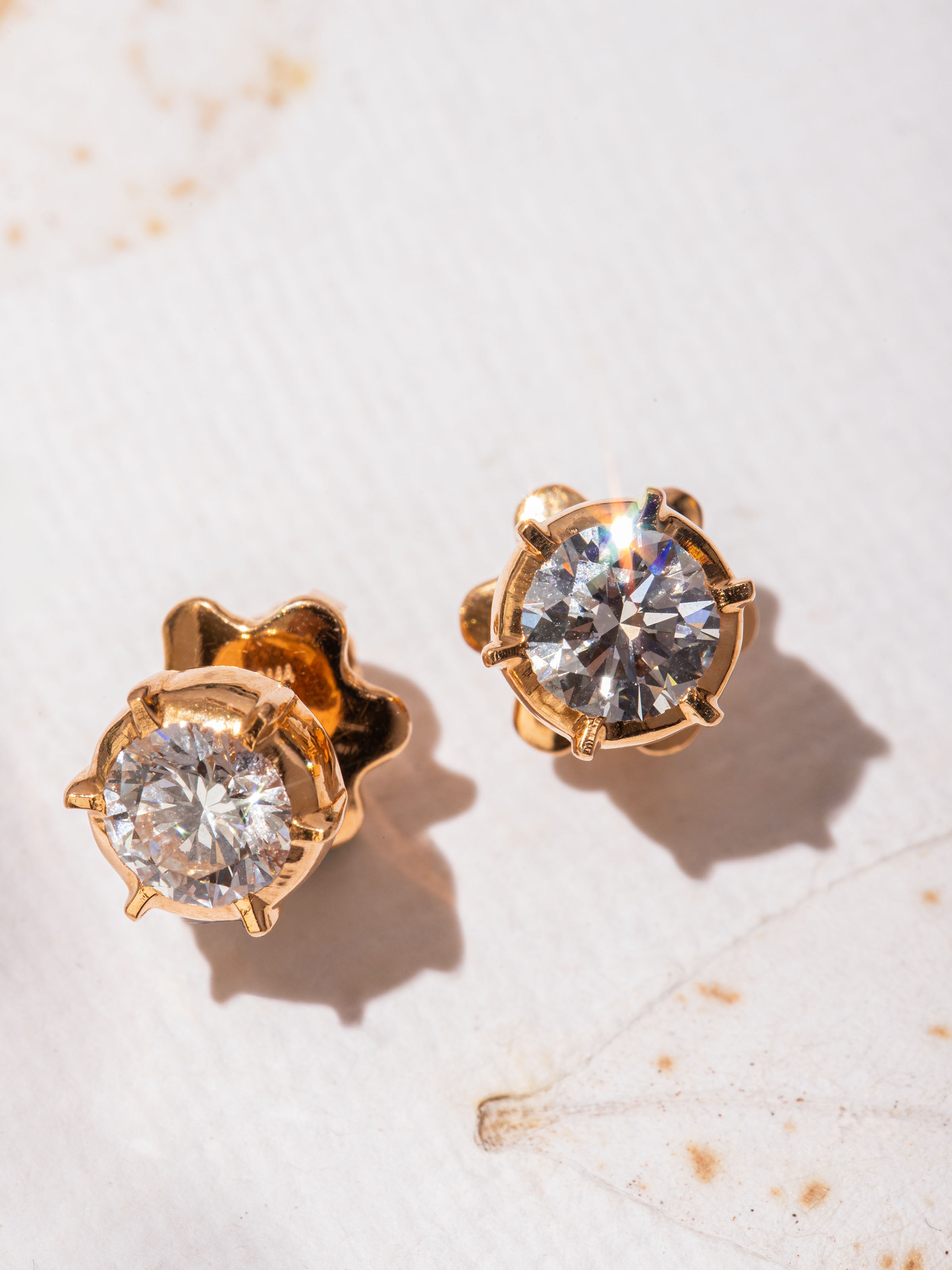 Alternate angle highlighting the gold studs’ refined curves and polished finish