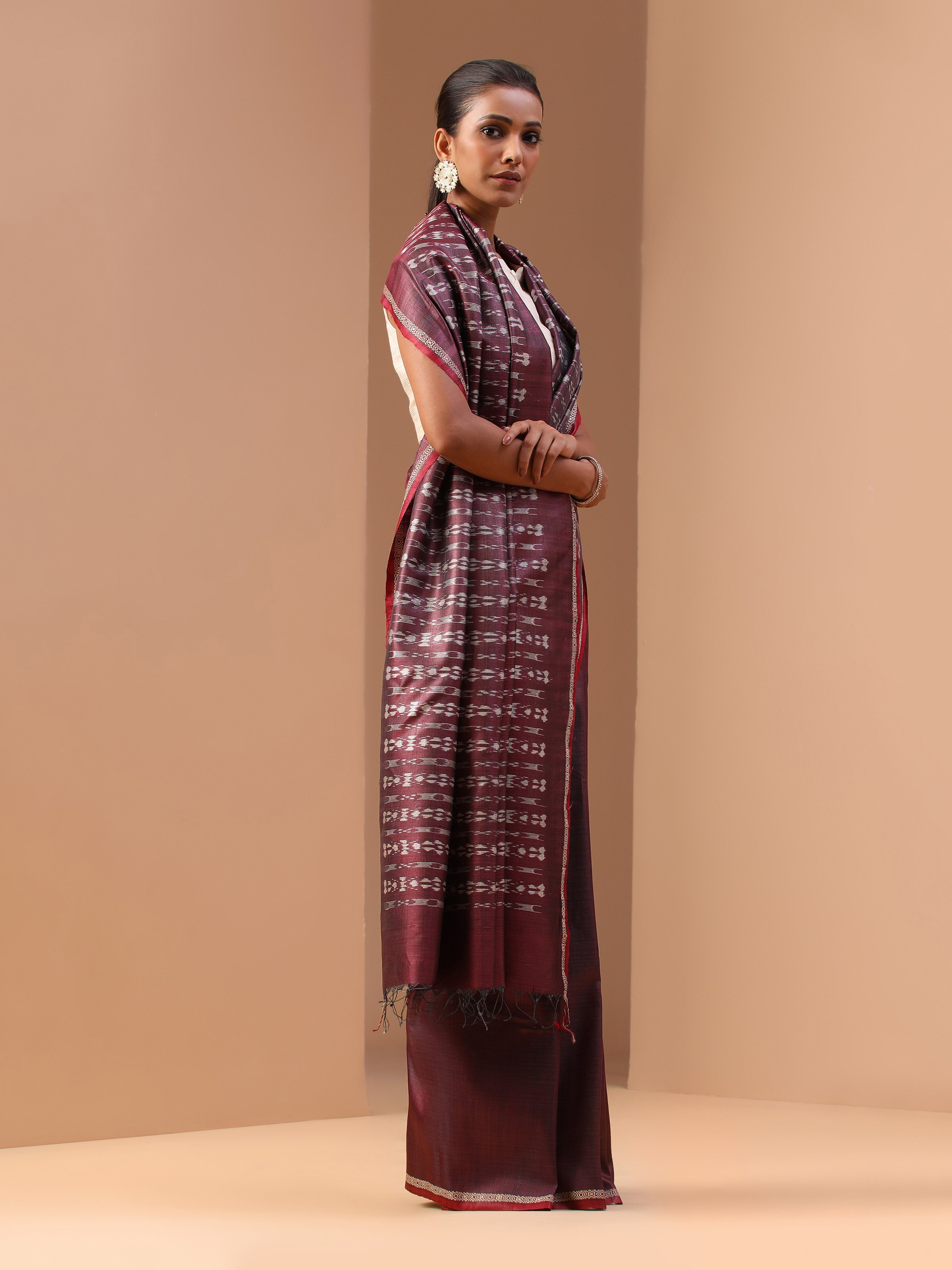 Alternate lifestyle angle of purple tussar silk Odisha Ikat saree showing detailed Ikat motifs.