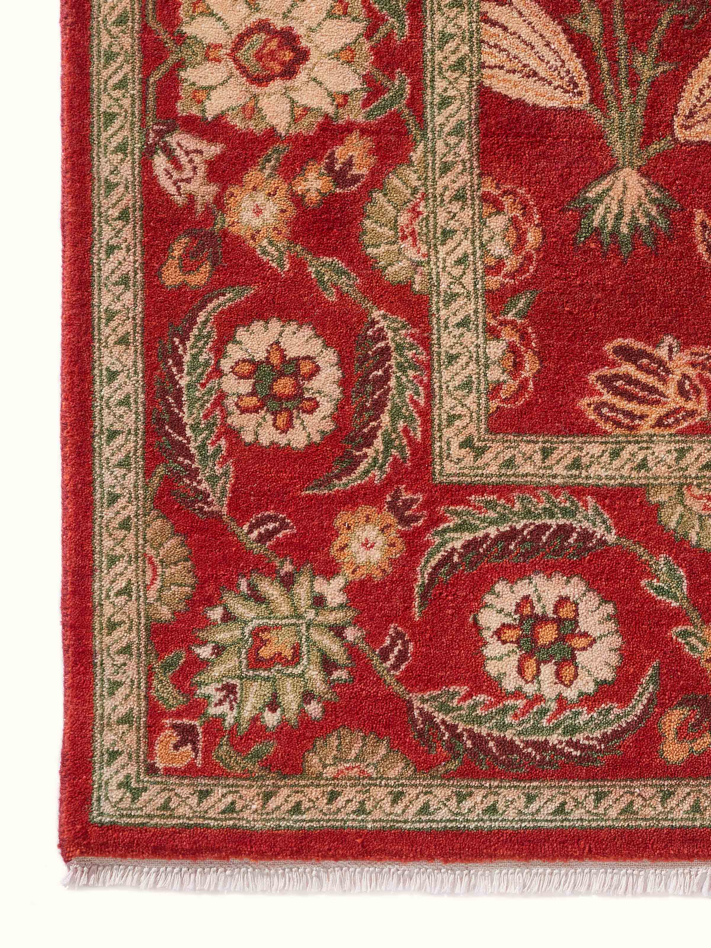 Close-up side detail of the Mughal Floral Red Carpet showing fine wool knots and detailed floral design