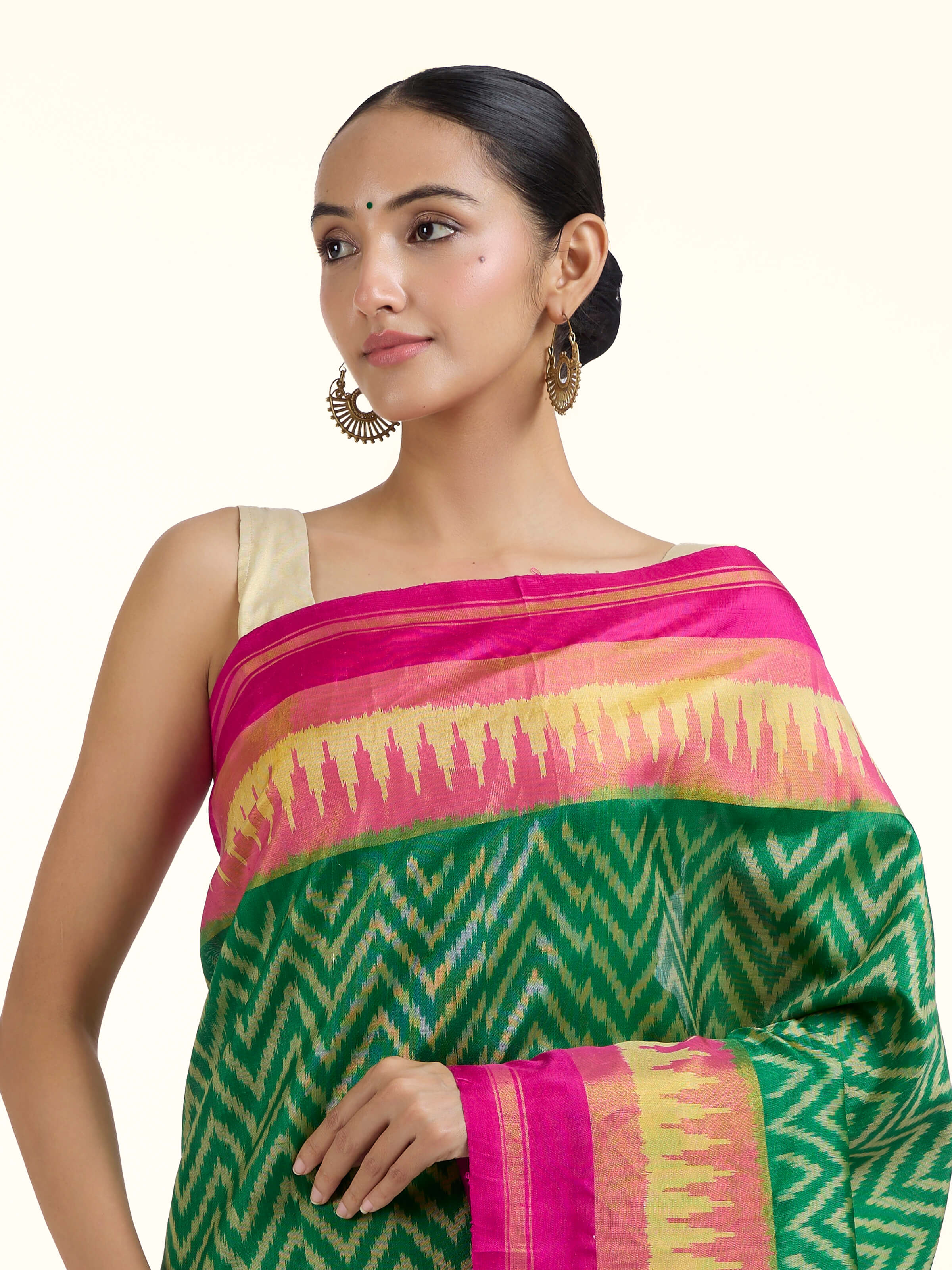 Angled view of green mulberry silk patola saree highlighting intricate patola craftsmanship