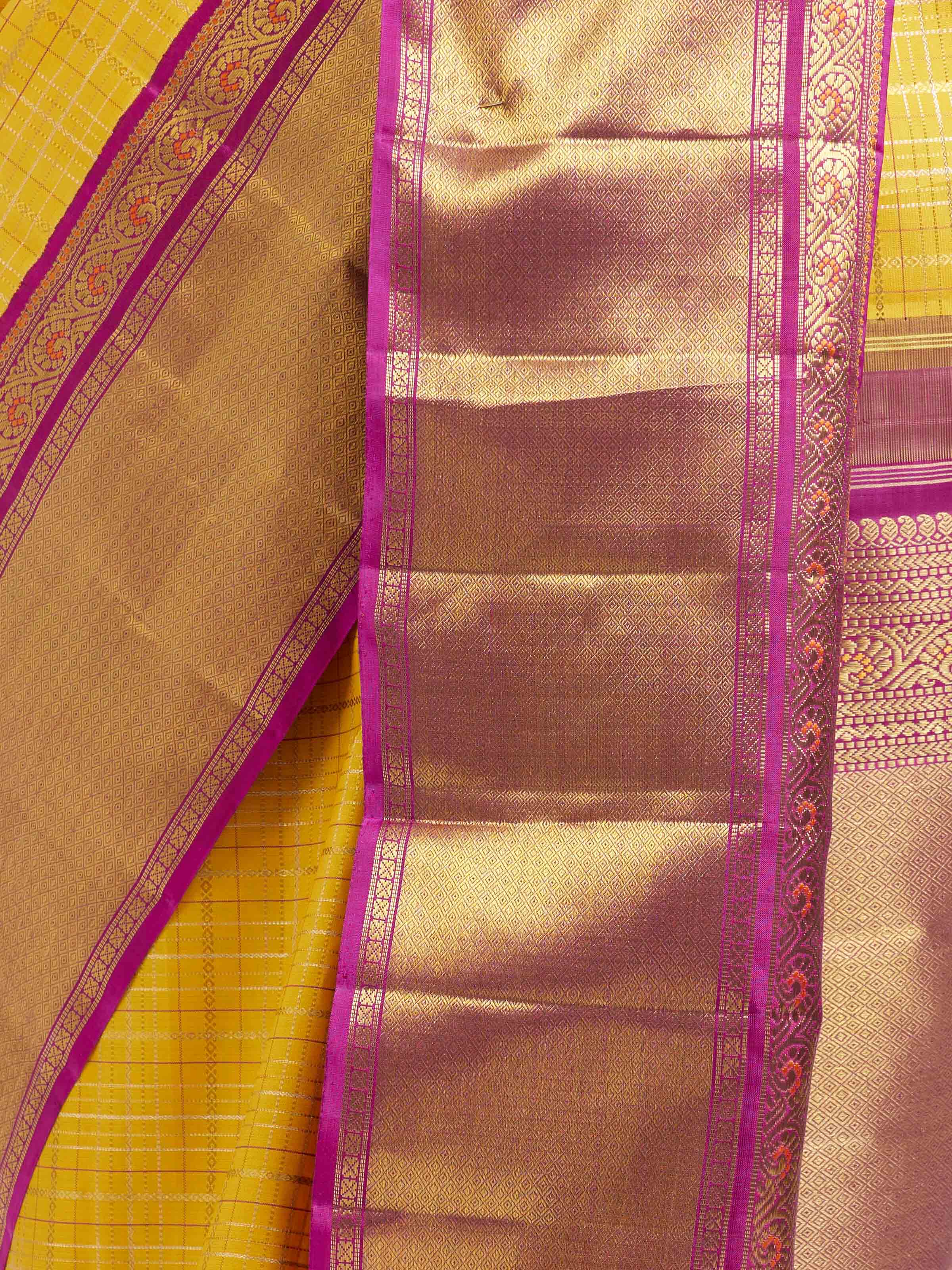 Detail view of yellow silk Kancheepuram saree showing silk texture and zari work
