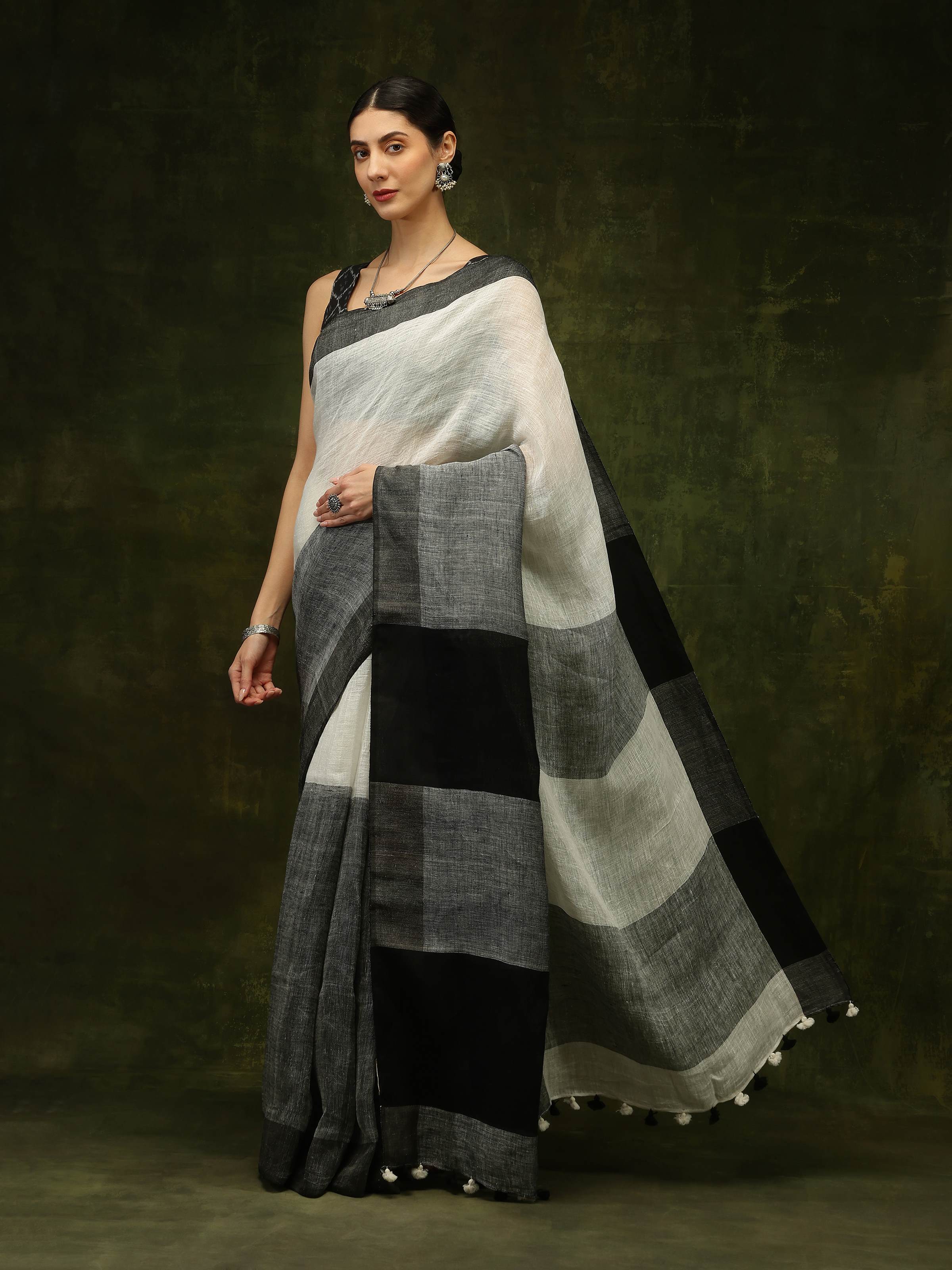Lifestyle view of black linen saree draped gracefully with contemporary styling