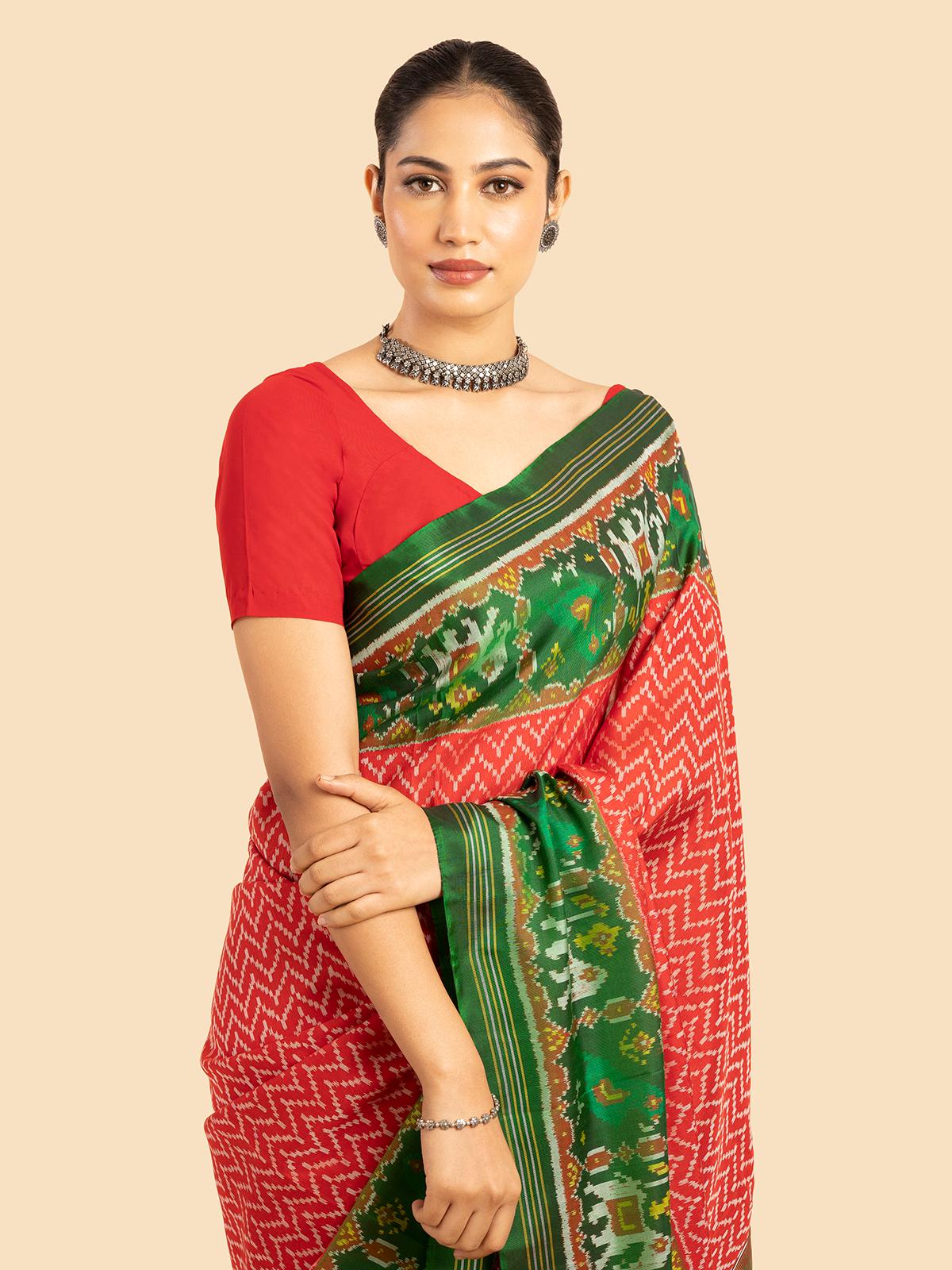 Close-up of red silk patola saree highlighting detailed design and color depth