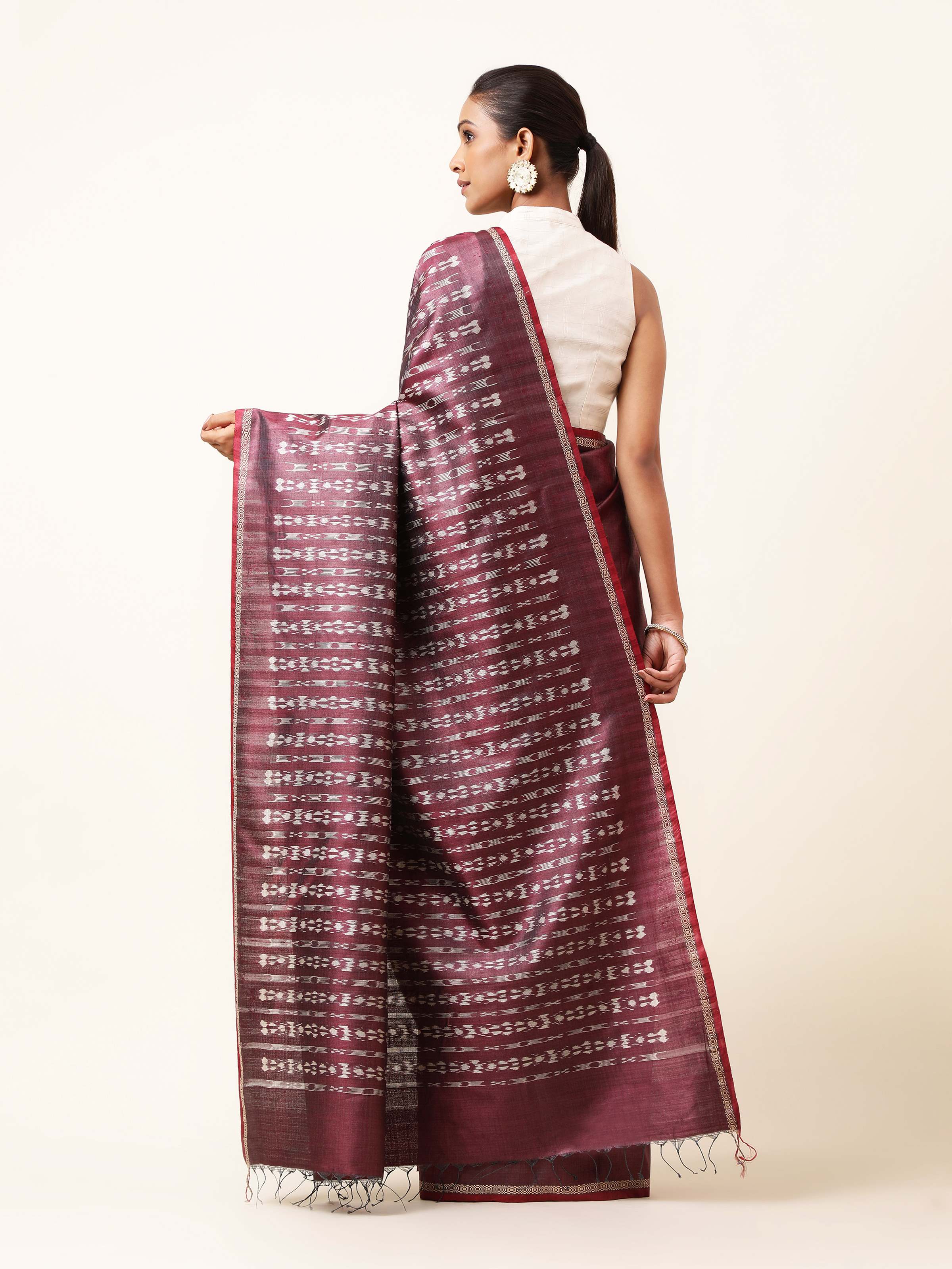 Back view of purple tussar silk Odisha Ikat saree displaying overall design and fabric finish.