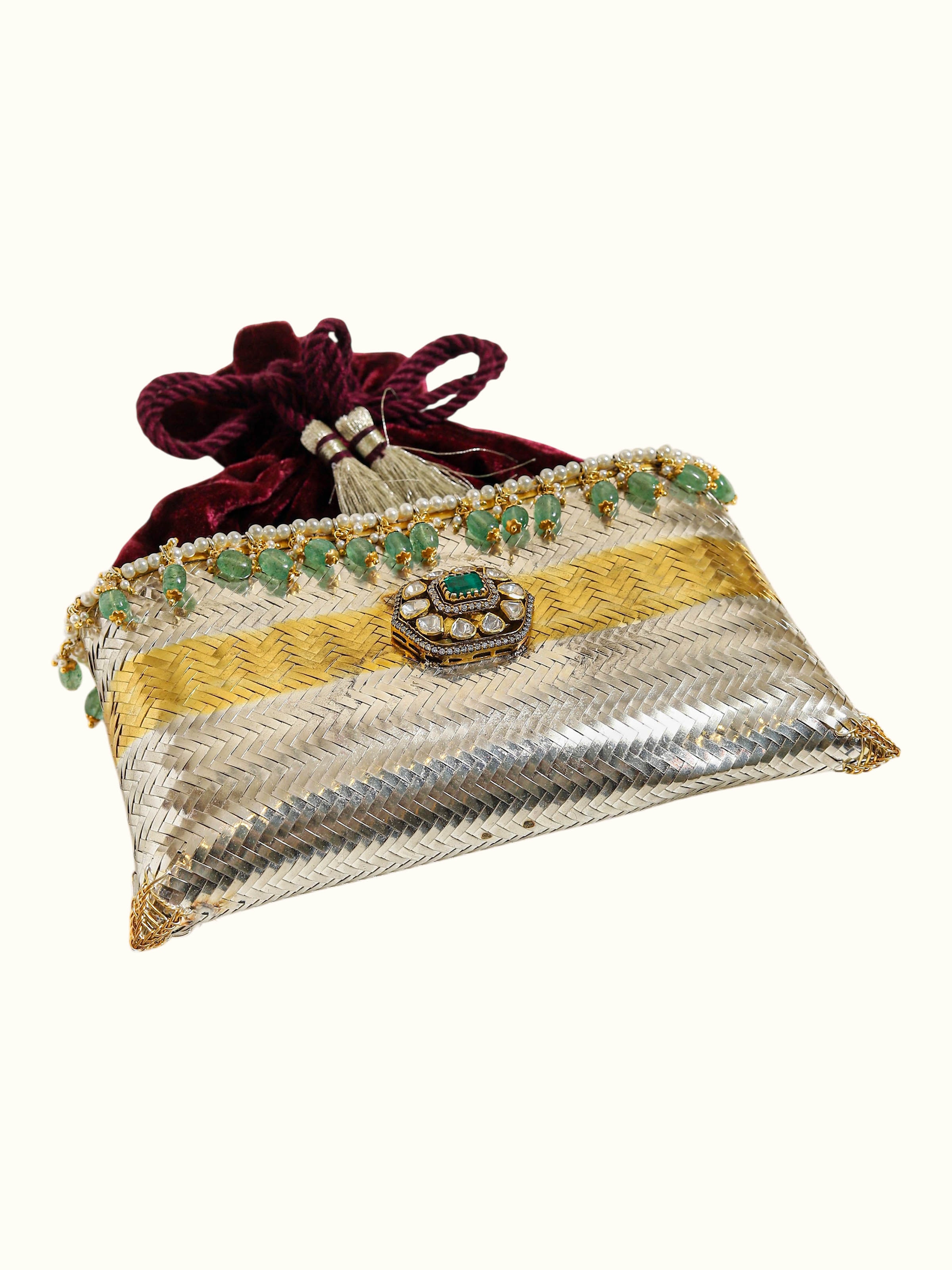 angled view of silver smithing two-tone potli-style bag