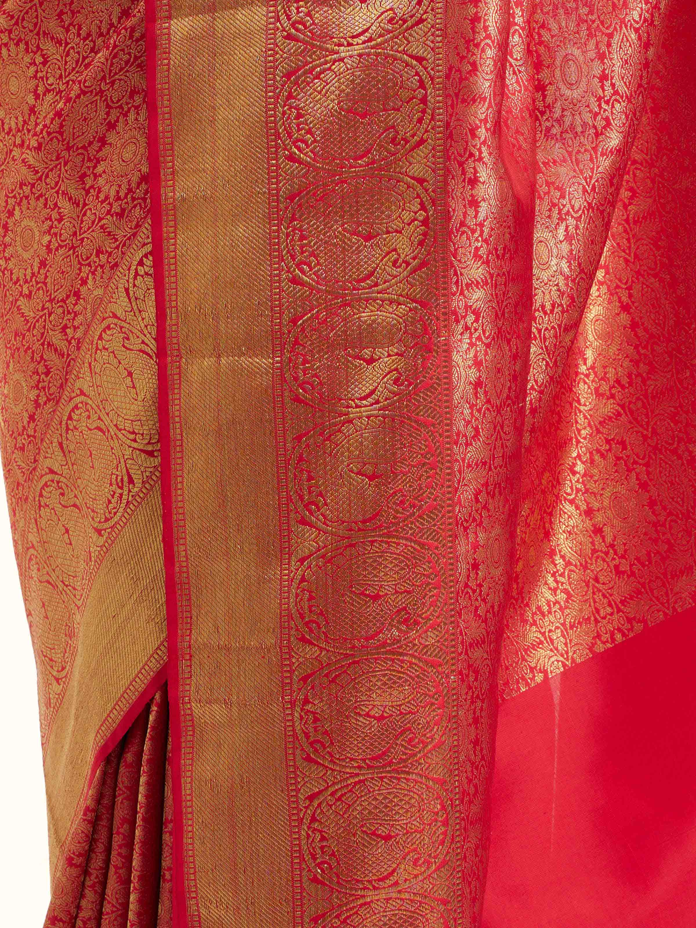Detail view of pink silk Kancheepuram saree showcasing silk texture and zari craftsmanship
