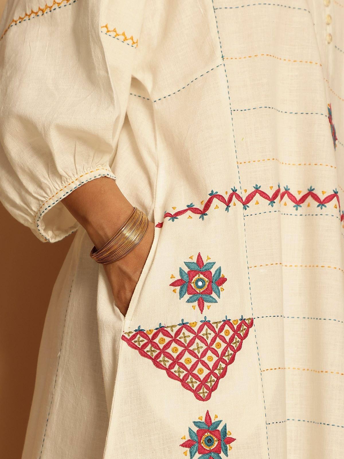 Side profile revealing the breezy silhouette and hand-embroidered patterns that speak of timeless artistry.