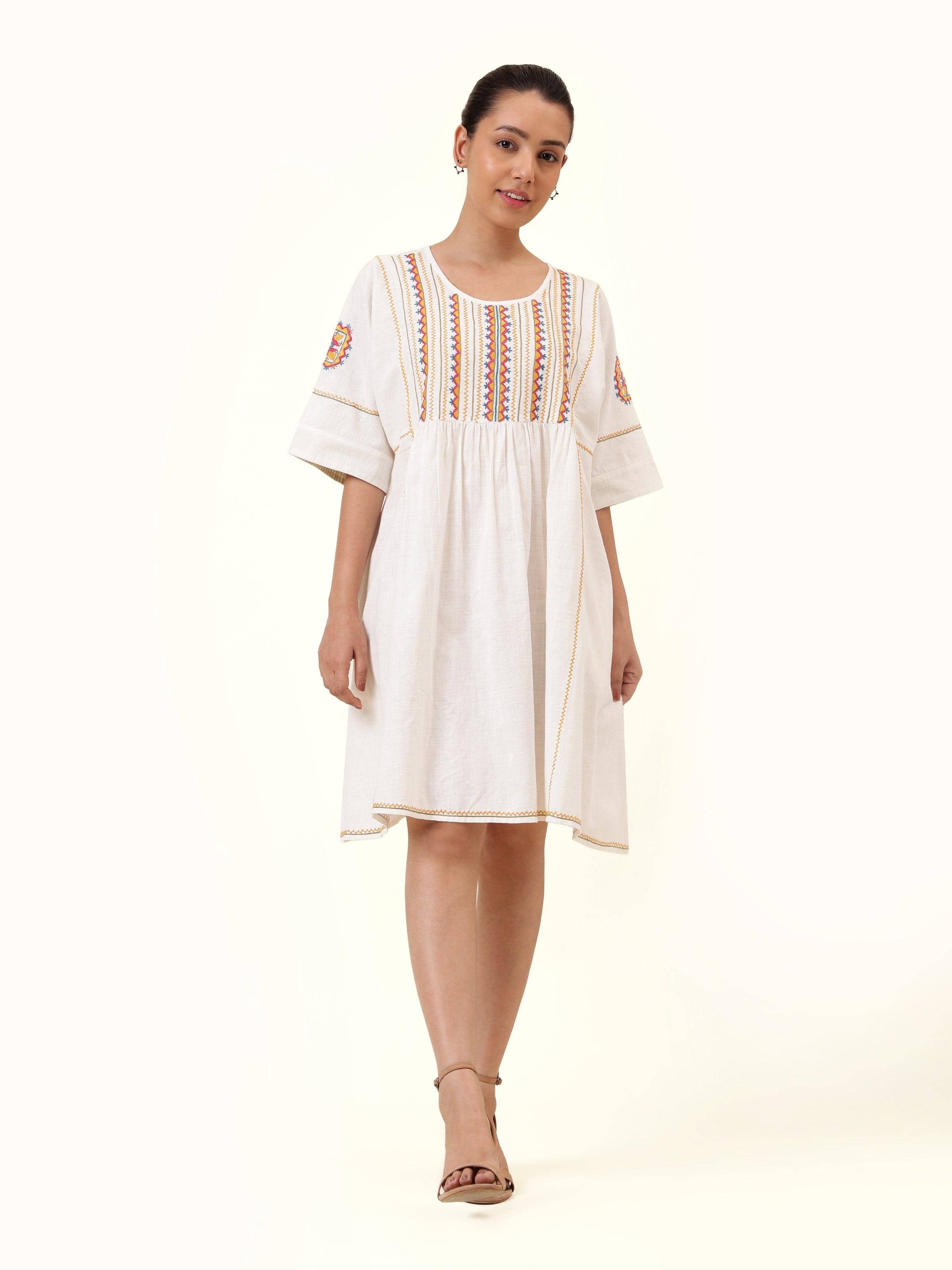 Front view of off-white short cotton Rajasthani embroidered dress showcasing delicate traditional embroidery and soft fabric texture.