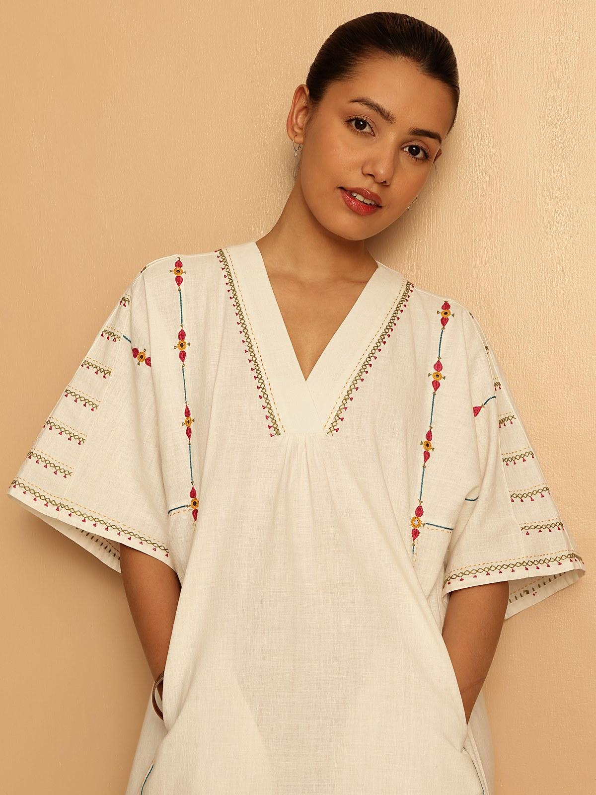 Close-up of the neckline to reveal detailed threadwork and embroidery.