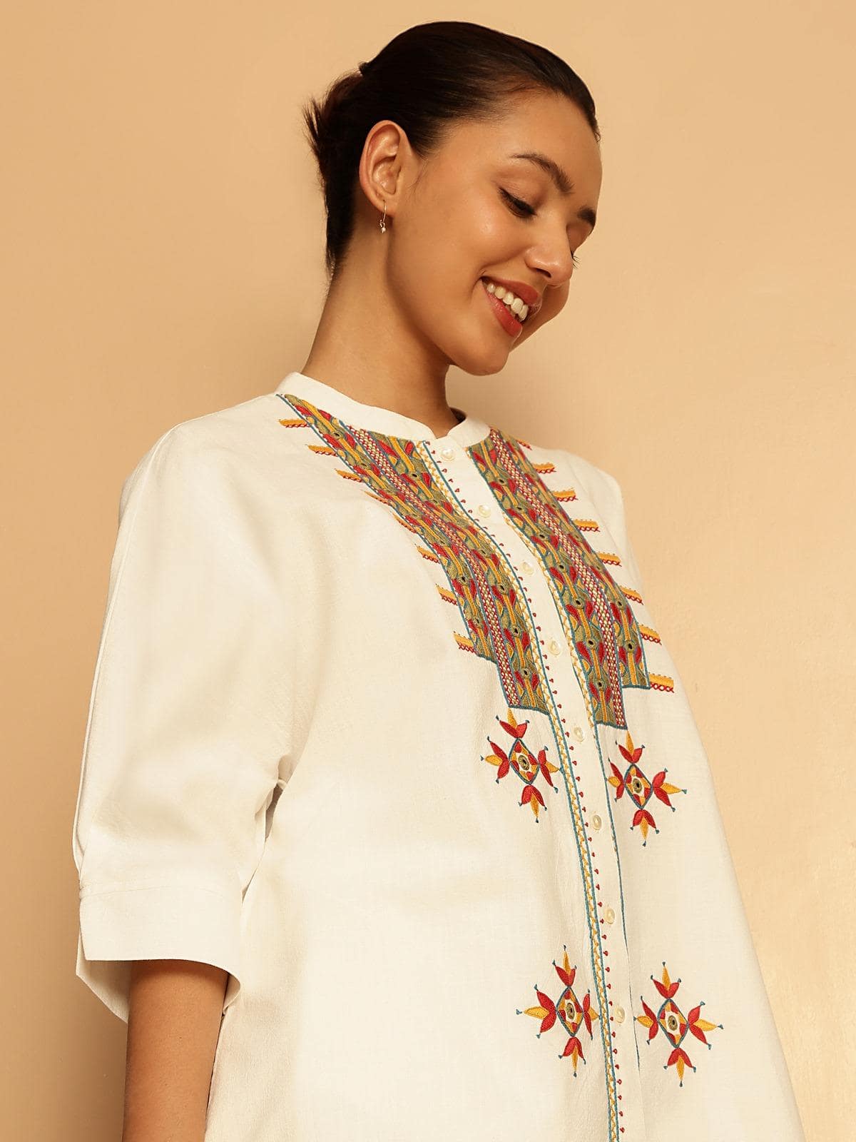 Angled view focusing on embroidery patterns and cotton fabric texture