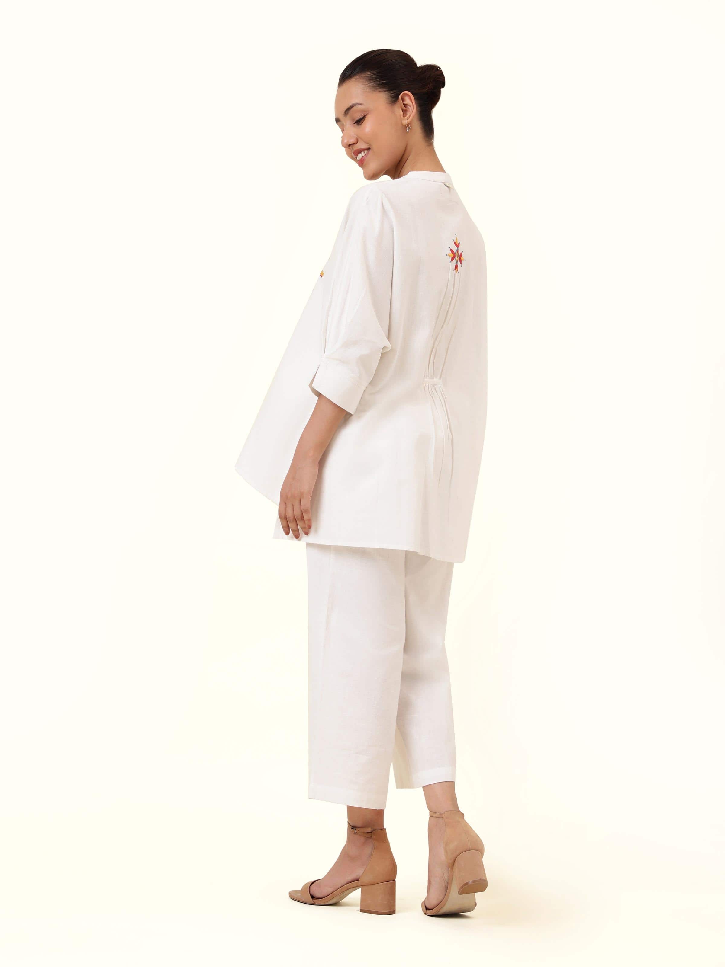 Back view showing neat tailoring and embroidery detail