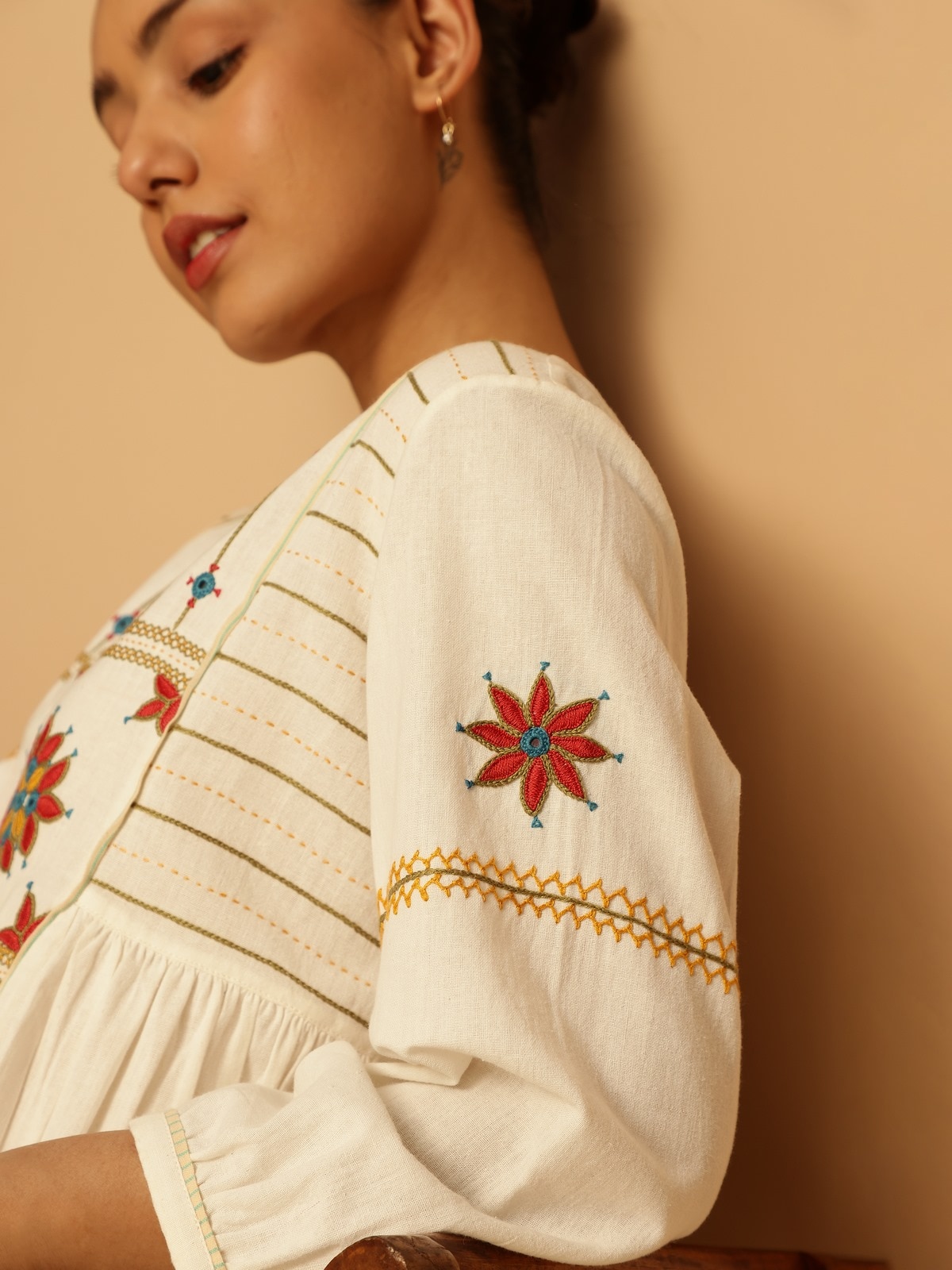 Rear lifestyle view showing back pleats and yoke continuation.