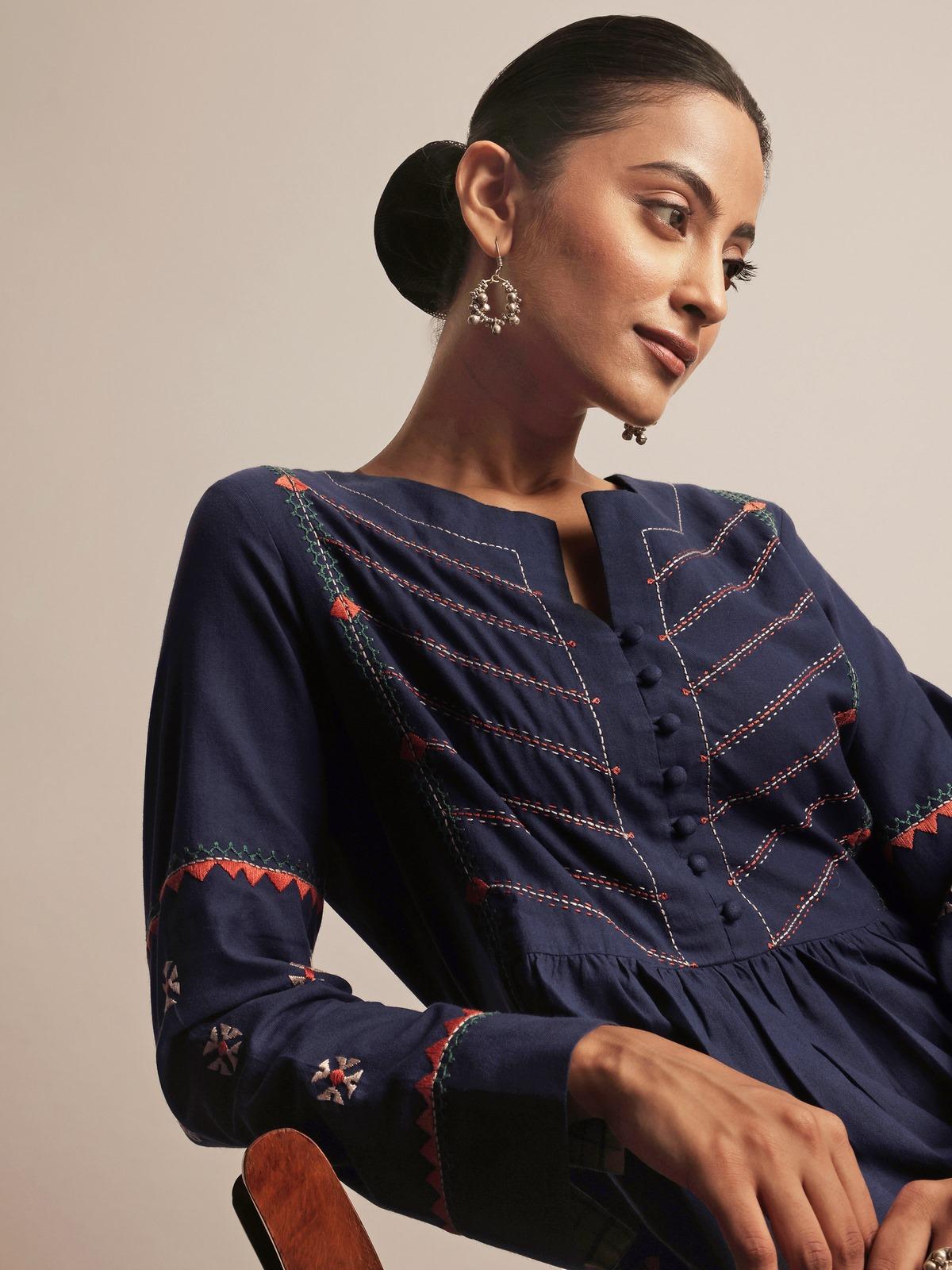 Side lifestyle view of indigo cotton kurta displaying rich texture and fine embroidery