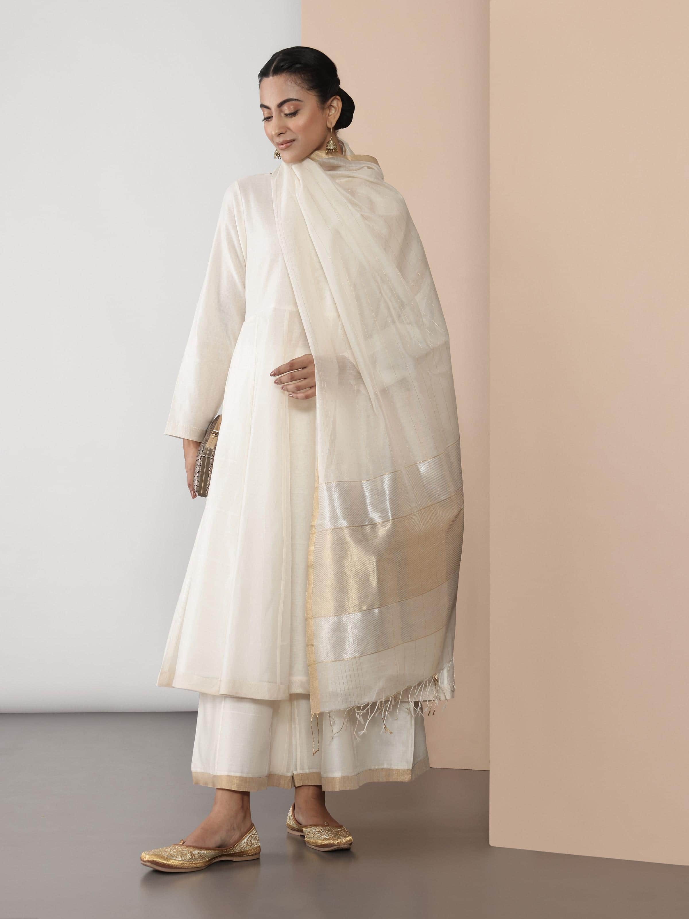 Side view of off-white Anarkali kurta showcasing its flowy Chanderi fabric and graceful fit.