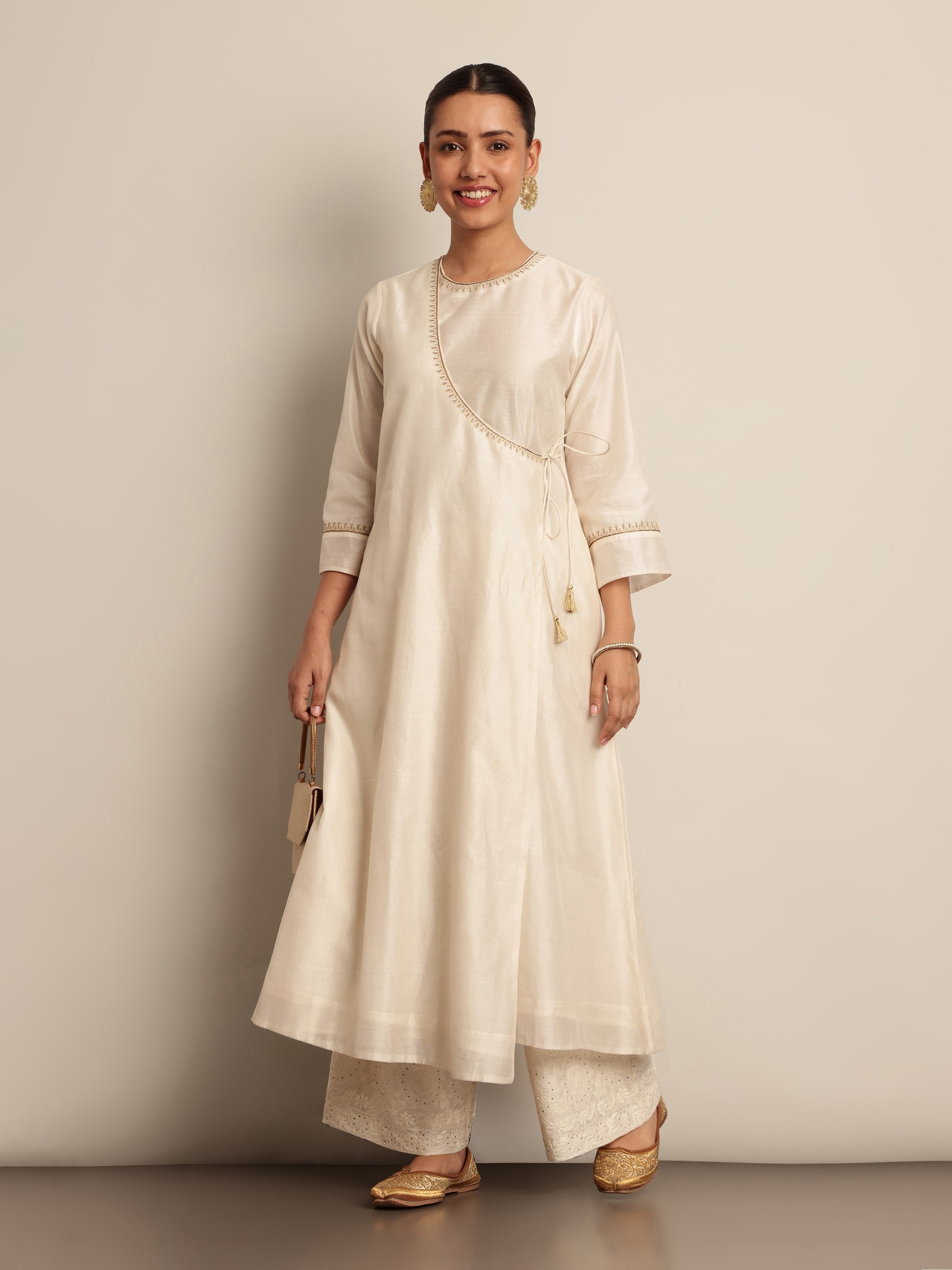 Model wearing Off-white A-Line Angrakha Kurta in Cotton Silk Chanderi, showcasing elegant drape and ethnic charm.