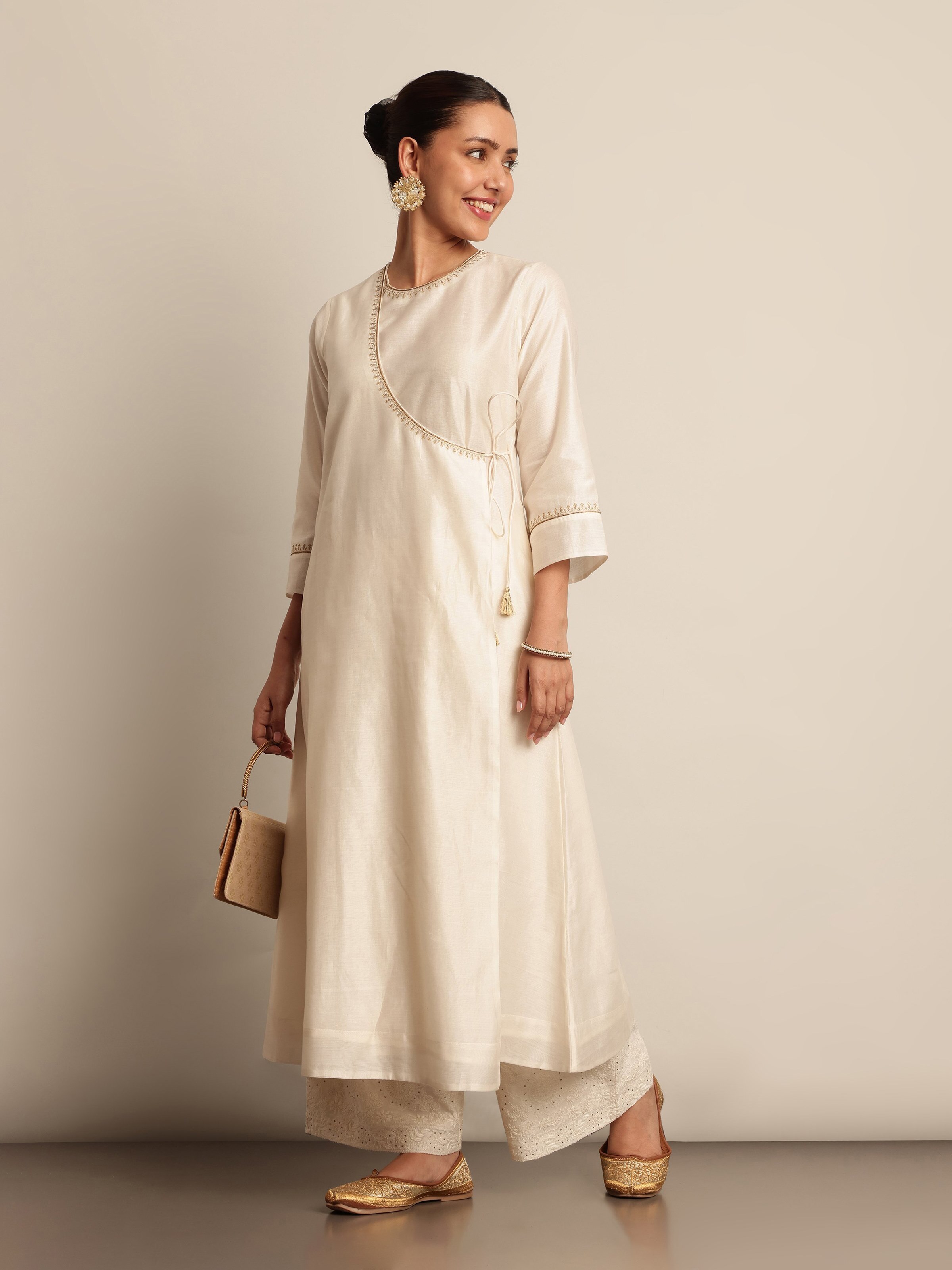 Side profile of model in Off-white Chanderi Angrakha Kurta, highlighting A-line silhouette and rich texture.