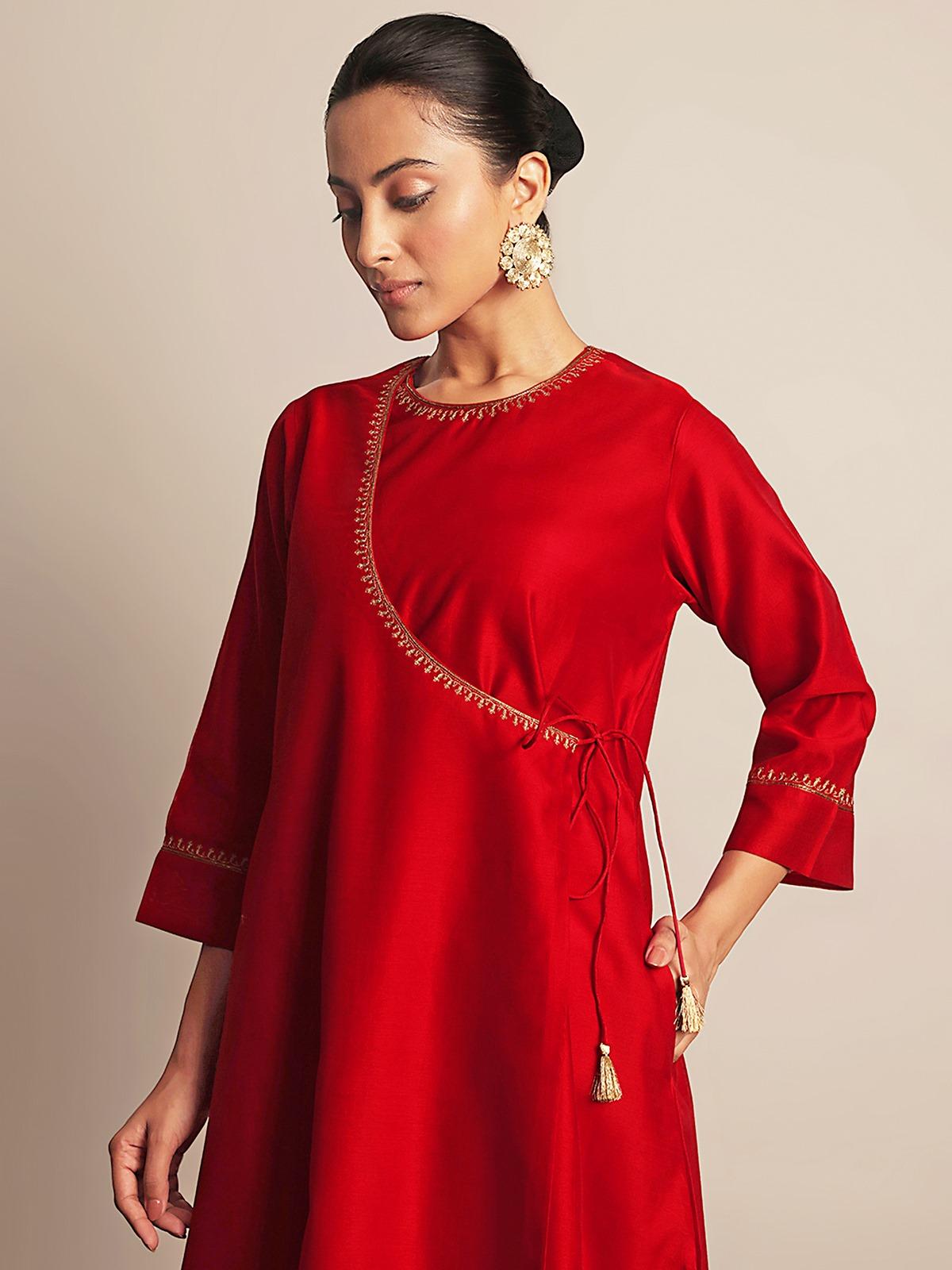 Side lifestyle view showing the side tie-up design and flare of the red Angrakha kurta.
