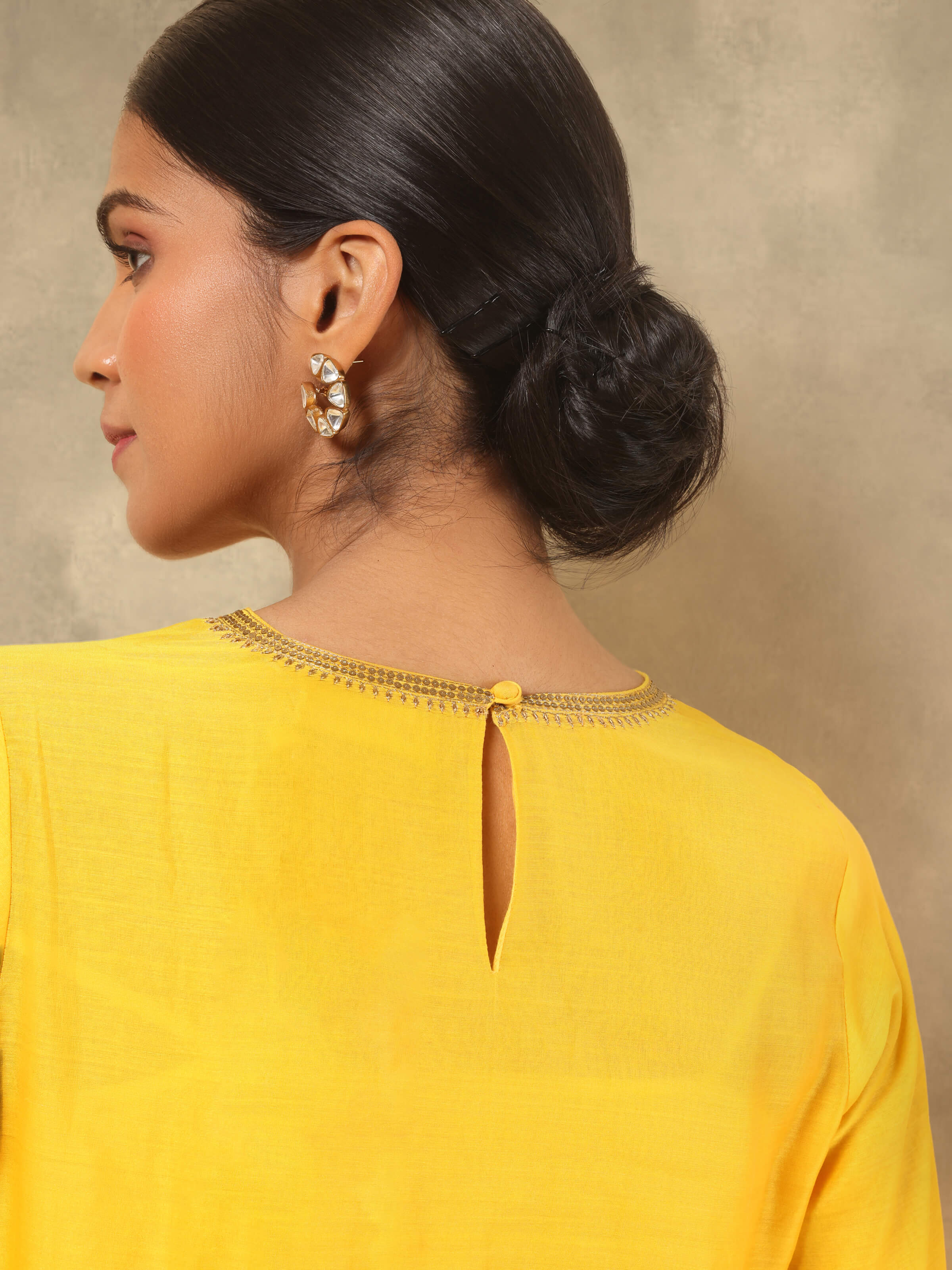 Angled view highlighting texture and flare of yellow cotton silk kurta