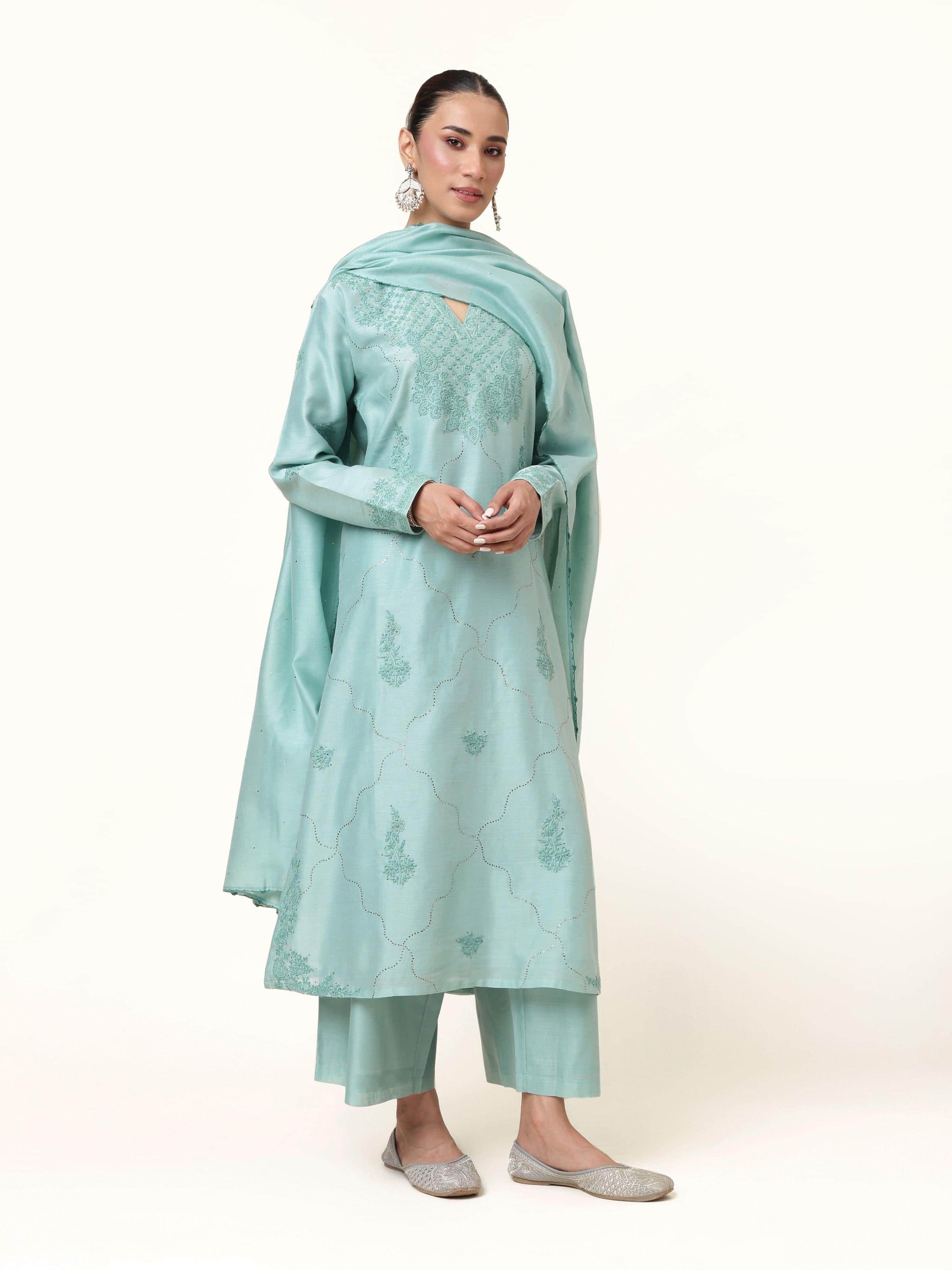 Front view of sea blue silk Chikankari kurta set featuring delicate embroidery.