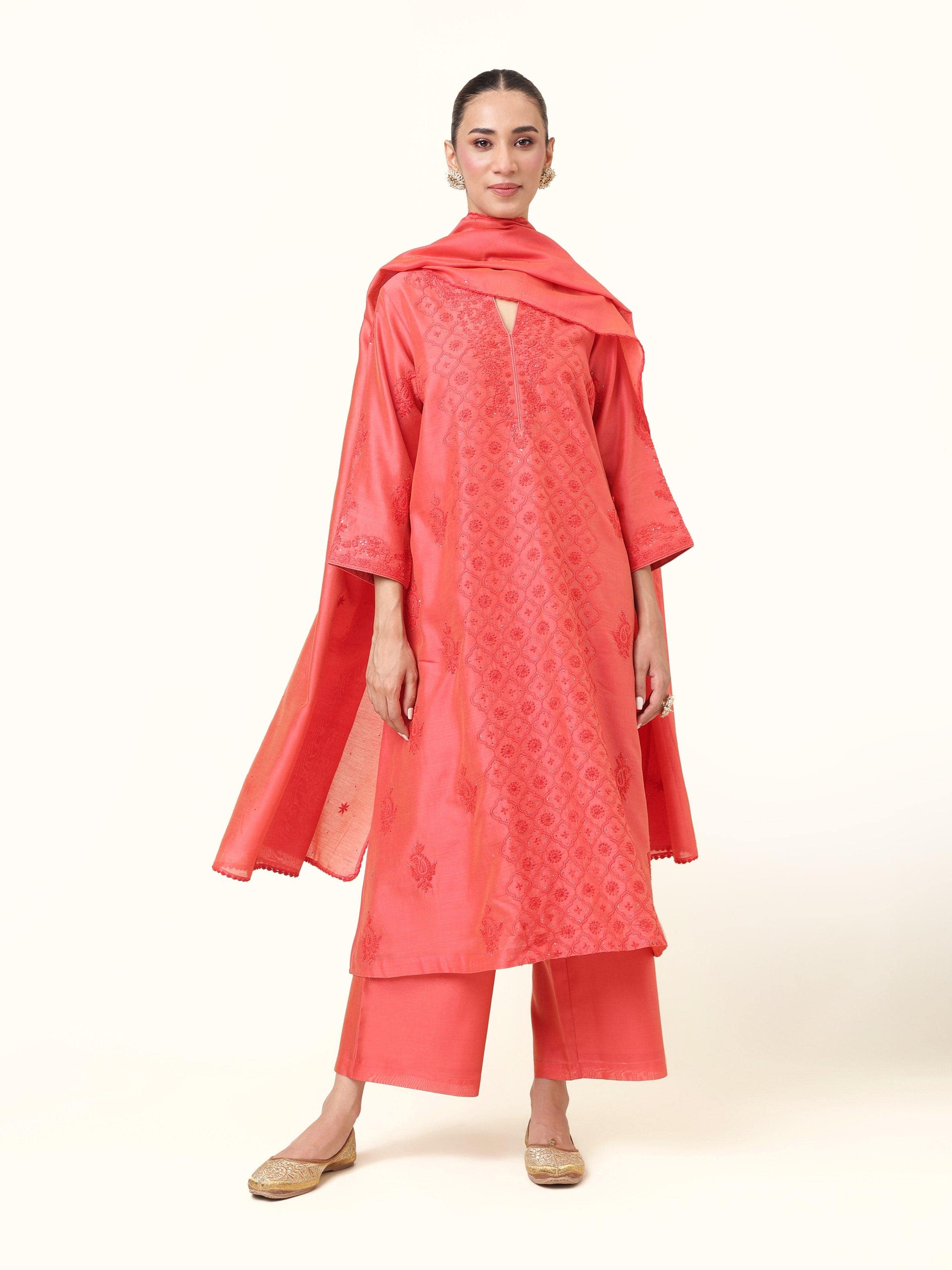 Front view of coral orange silk Chikankari kurta set showing embroidered detailing.