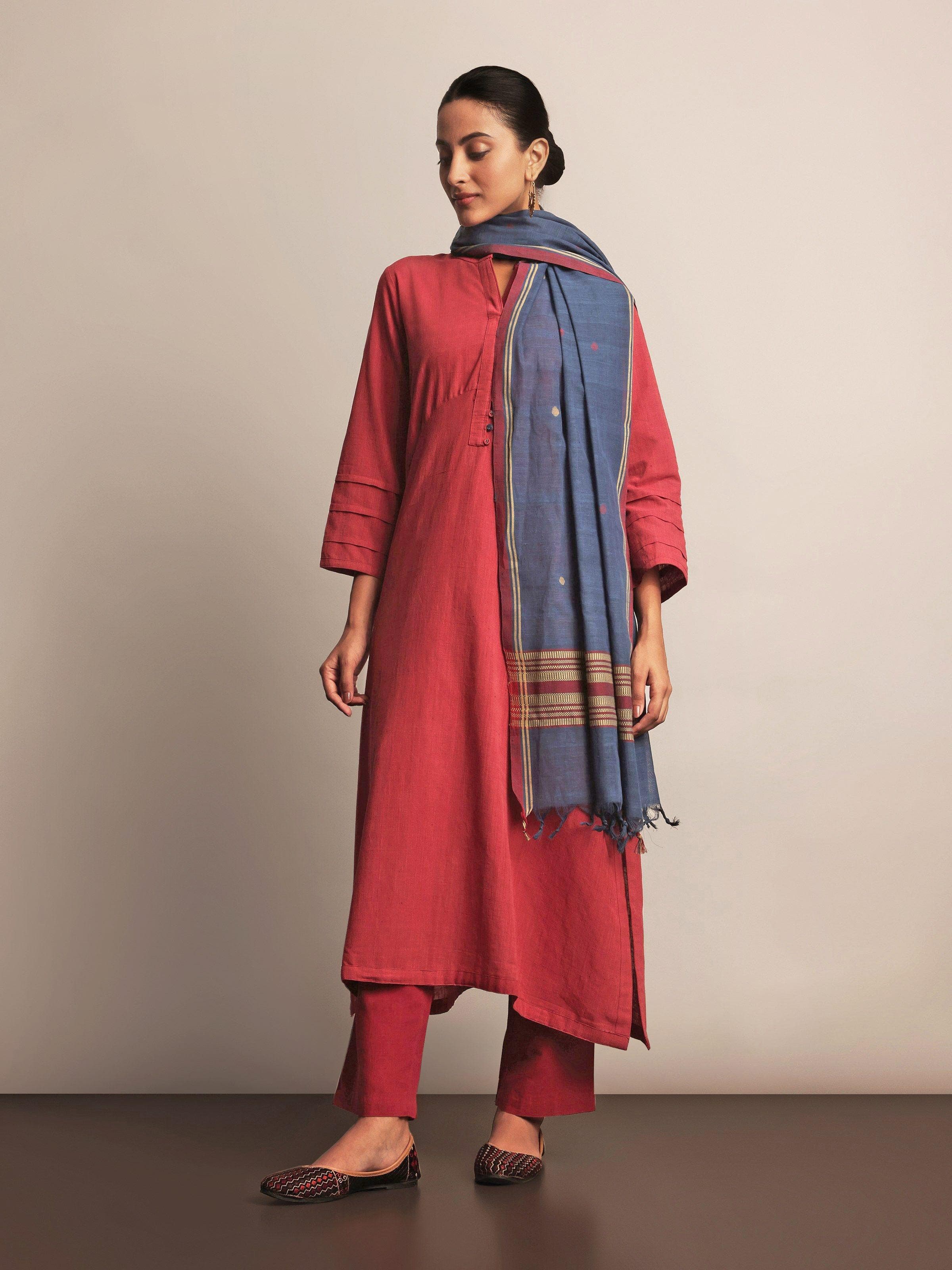 Lifestyle view of red cotton pant paired with a kurta for a minimal ethnic look