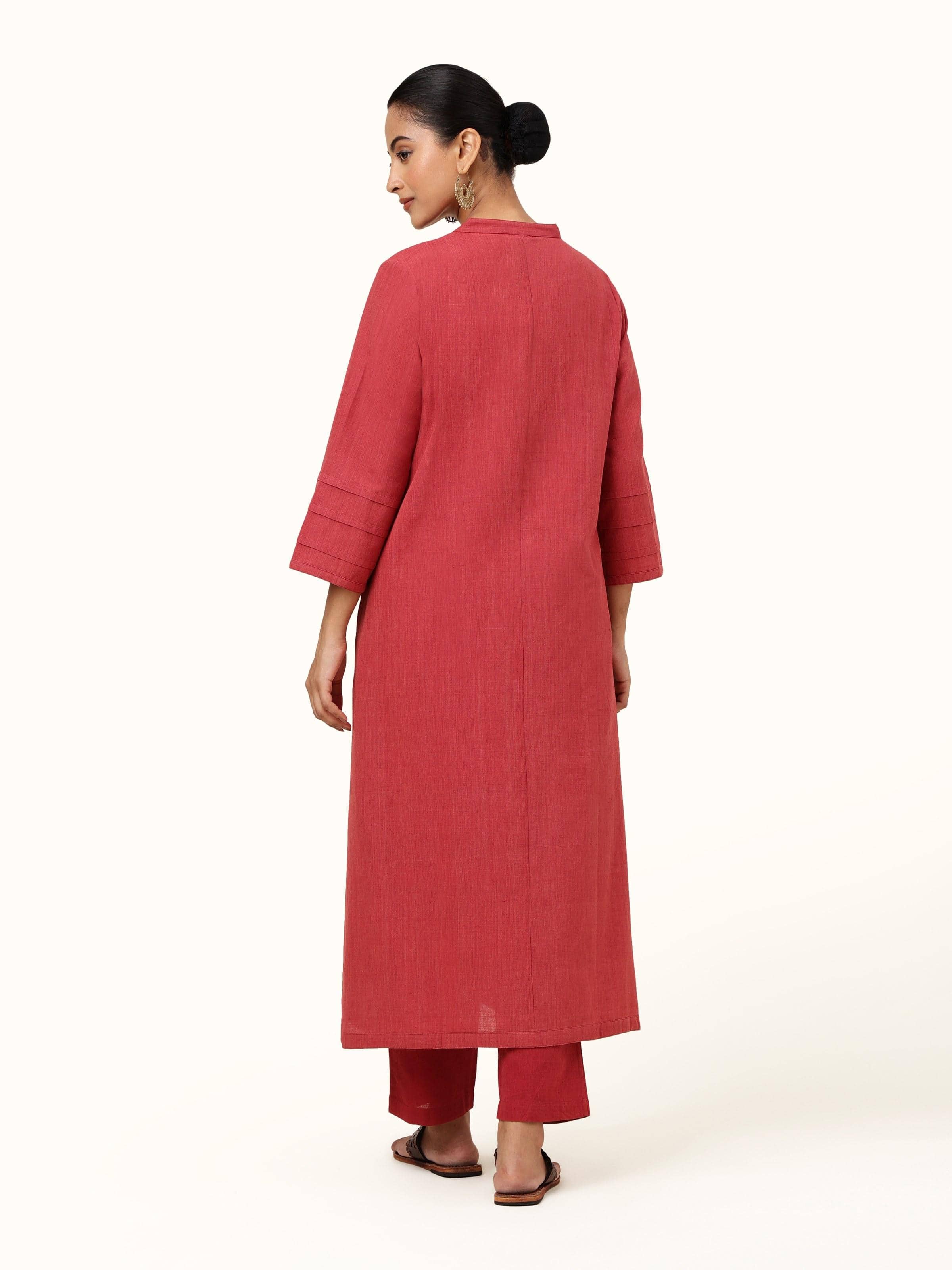 Back view of red cotton straight-cut pant displaying plain design and even seam