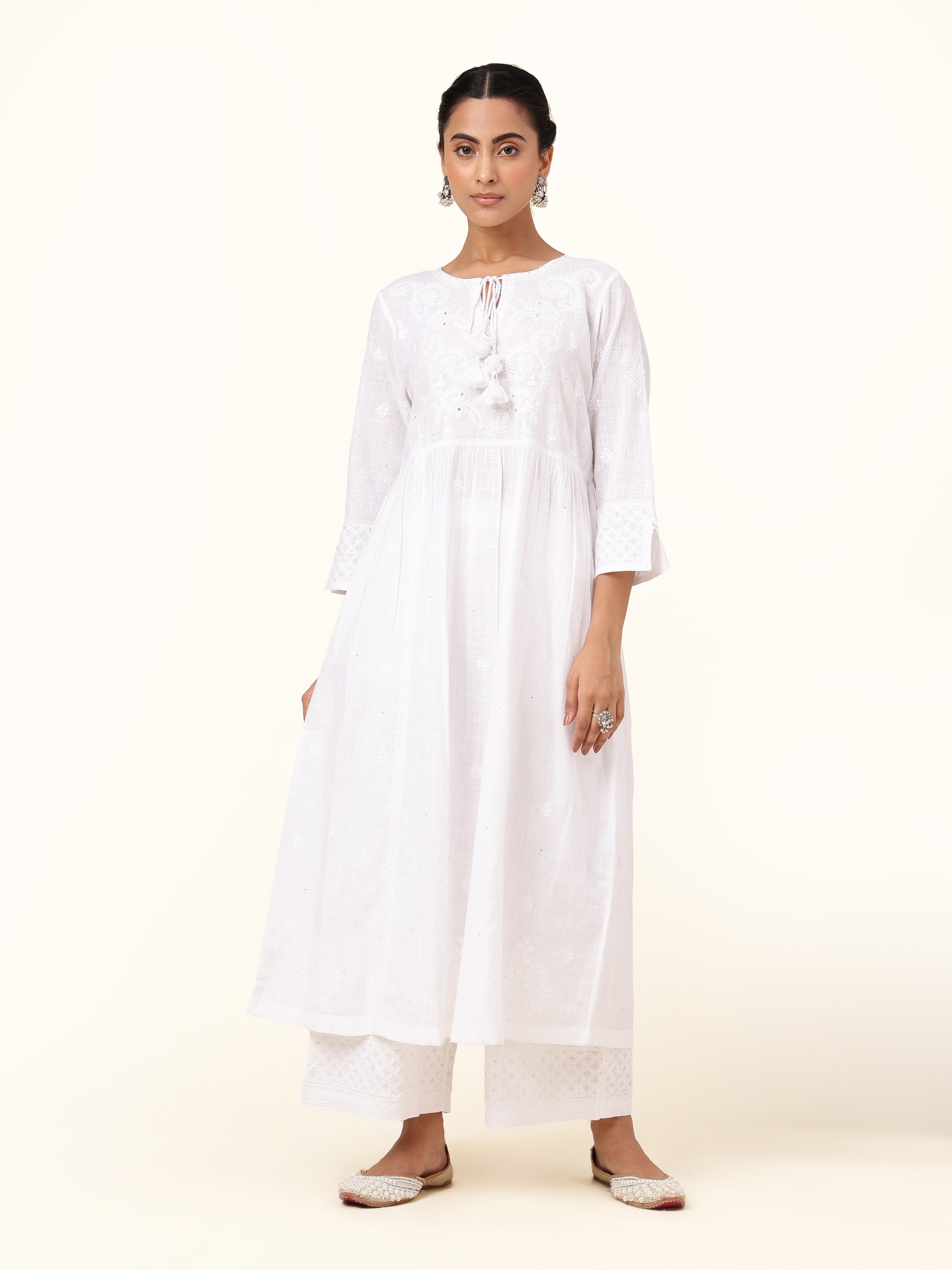 Front view of white cotton chikankari kurta featuring intricate hand embroidery.