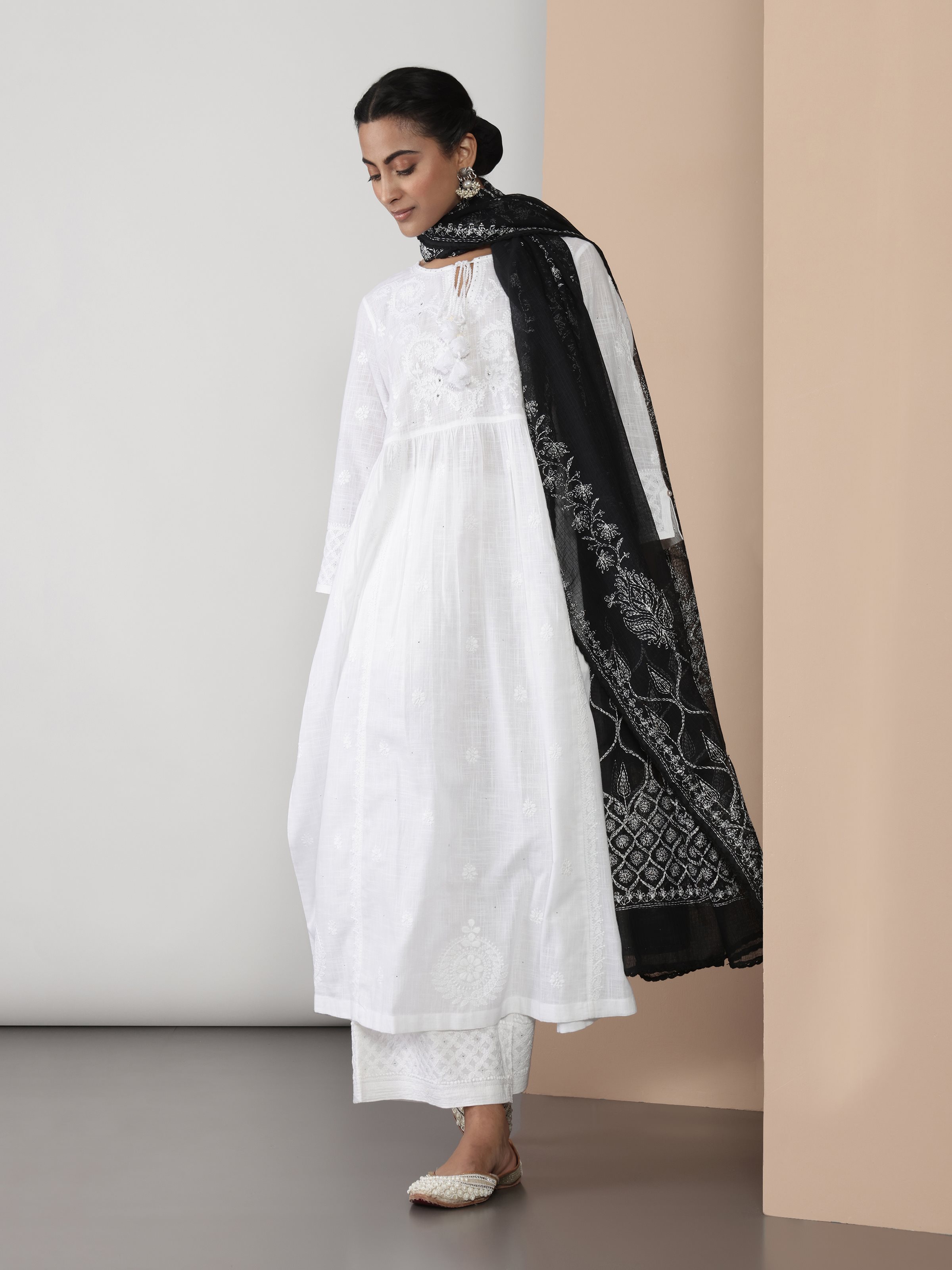 Lifestyle shot of white cotton chikankari kurta worn casually to highlight embroidery and comfort.