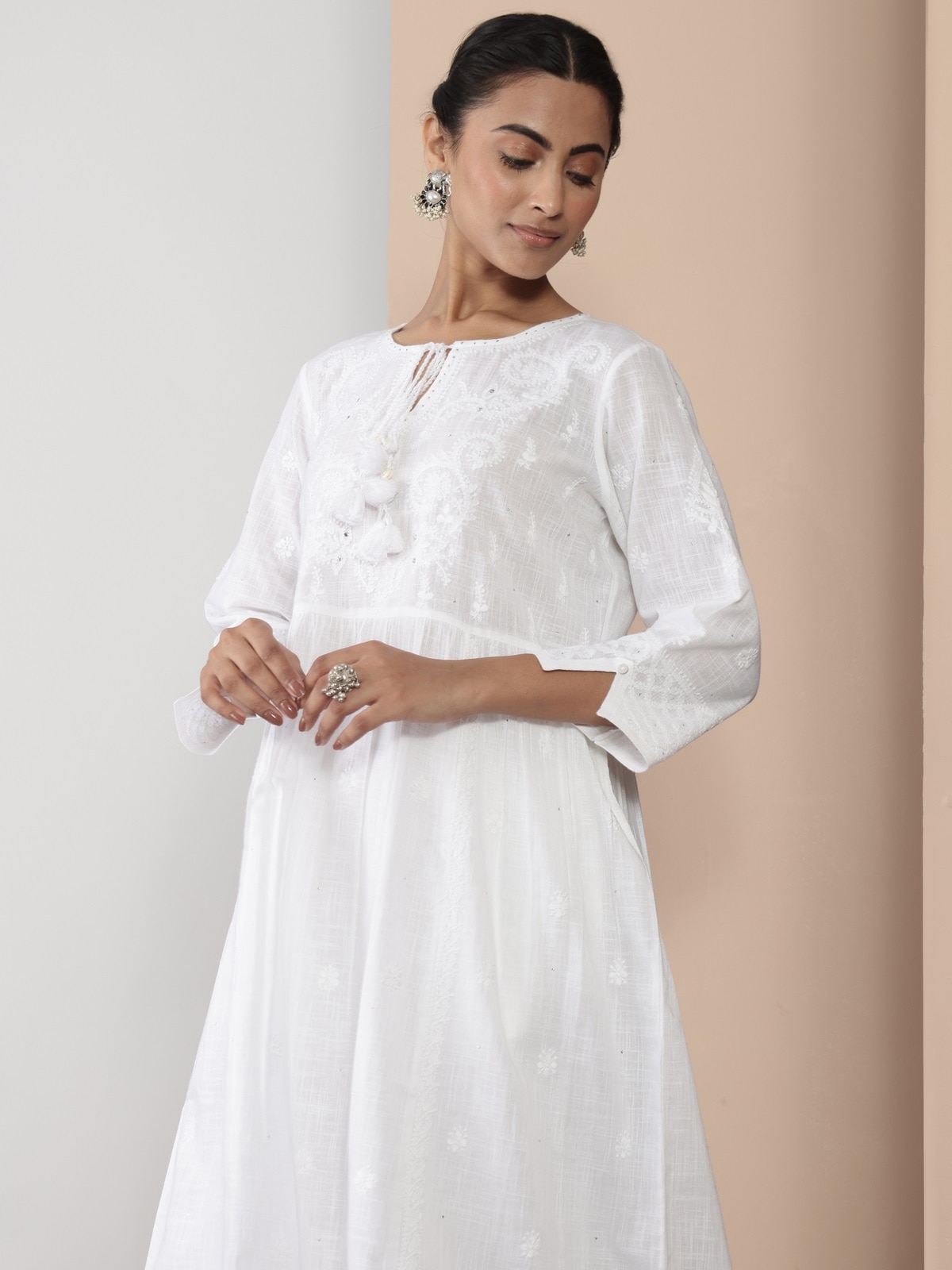 Angled view of chikankari kurta showing delicate stitching and fabric texture.