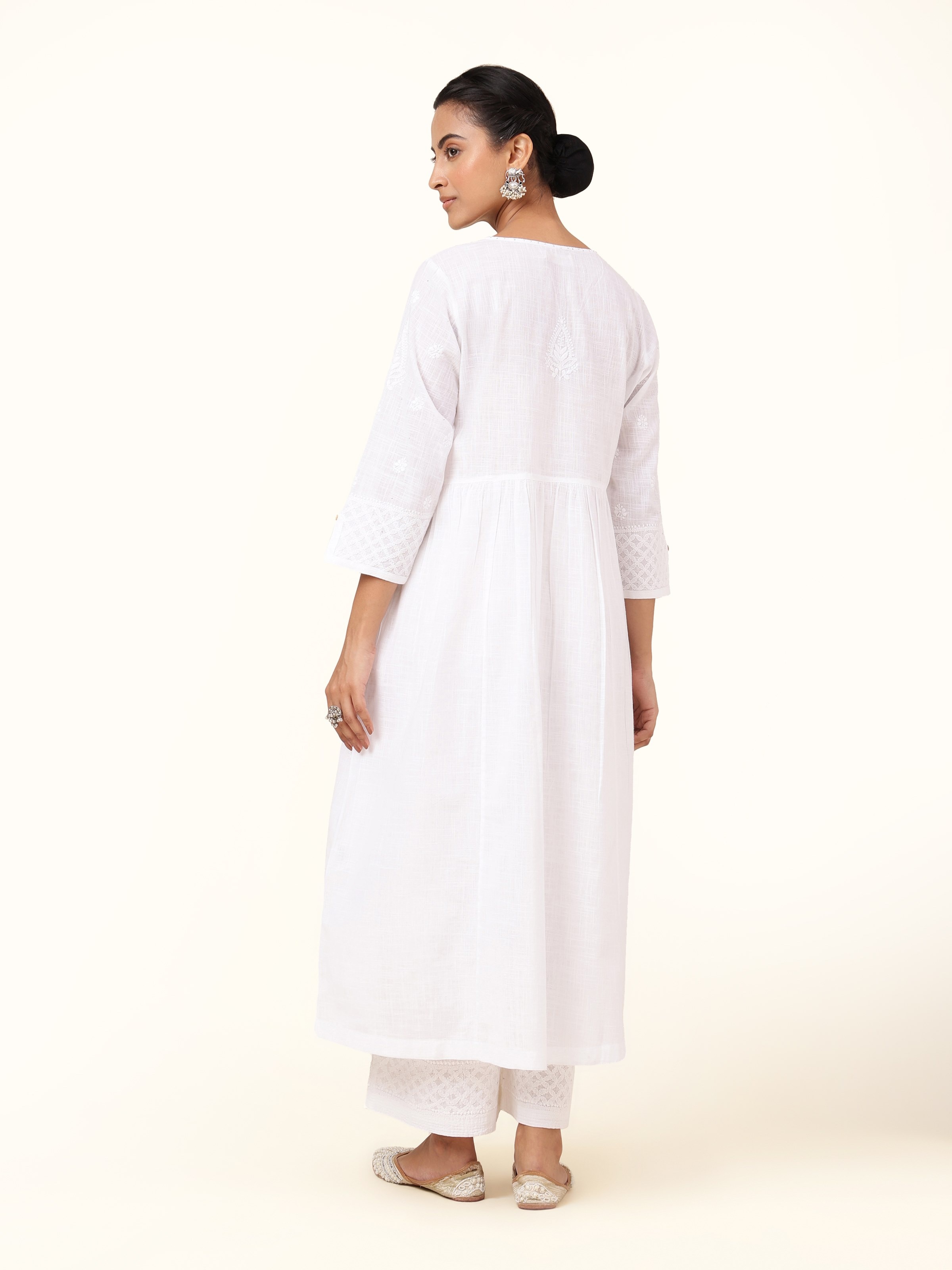 Back view of white chikankari kurta displaying overall design and fabric flow.