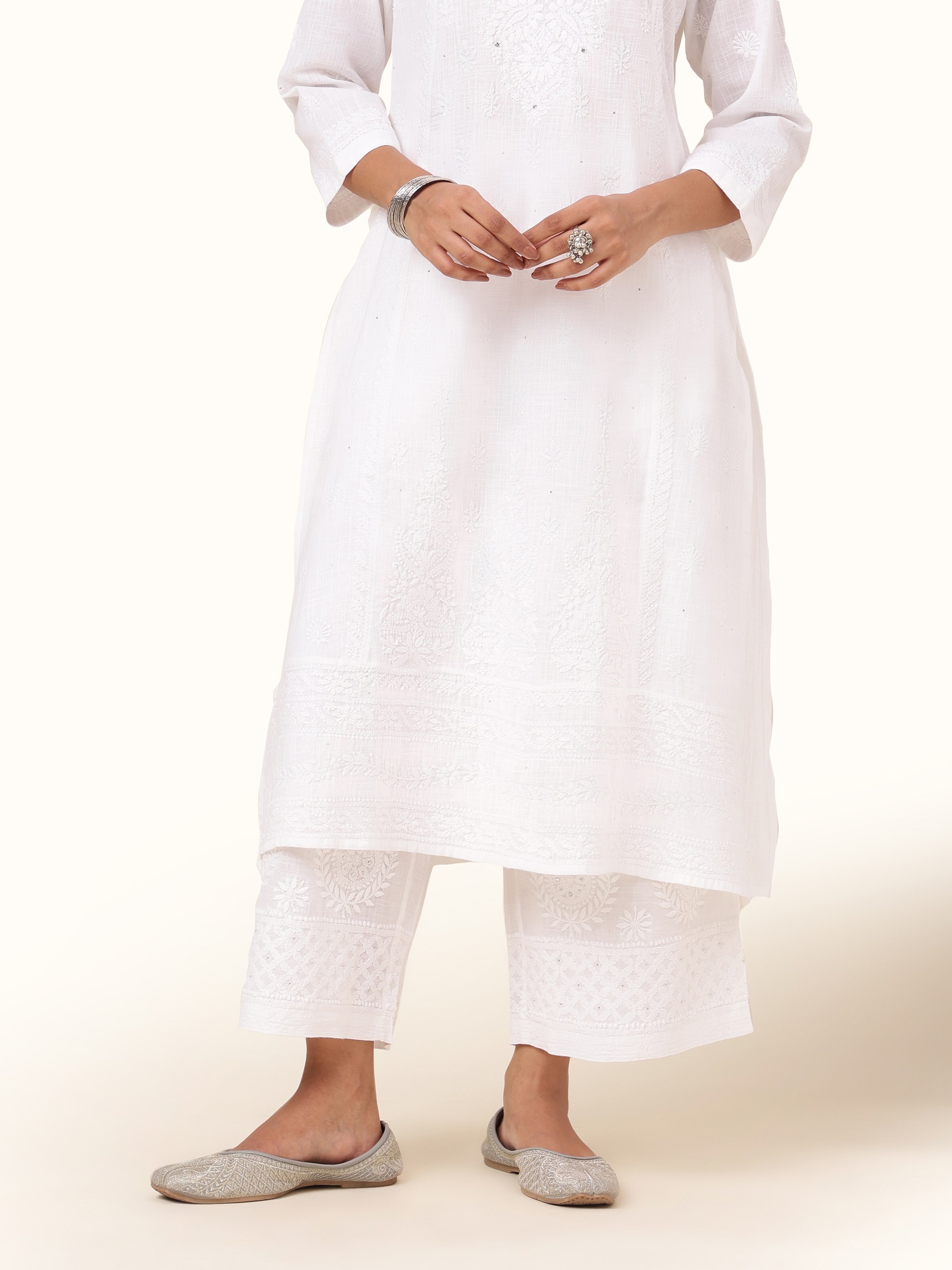 Front view of white cotton Chikankari palazzo with floral embroidery and wide-leg fit.