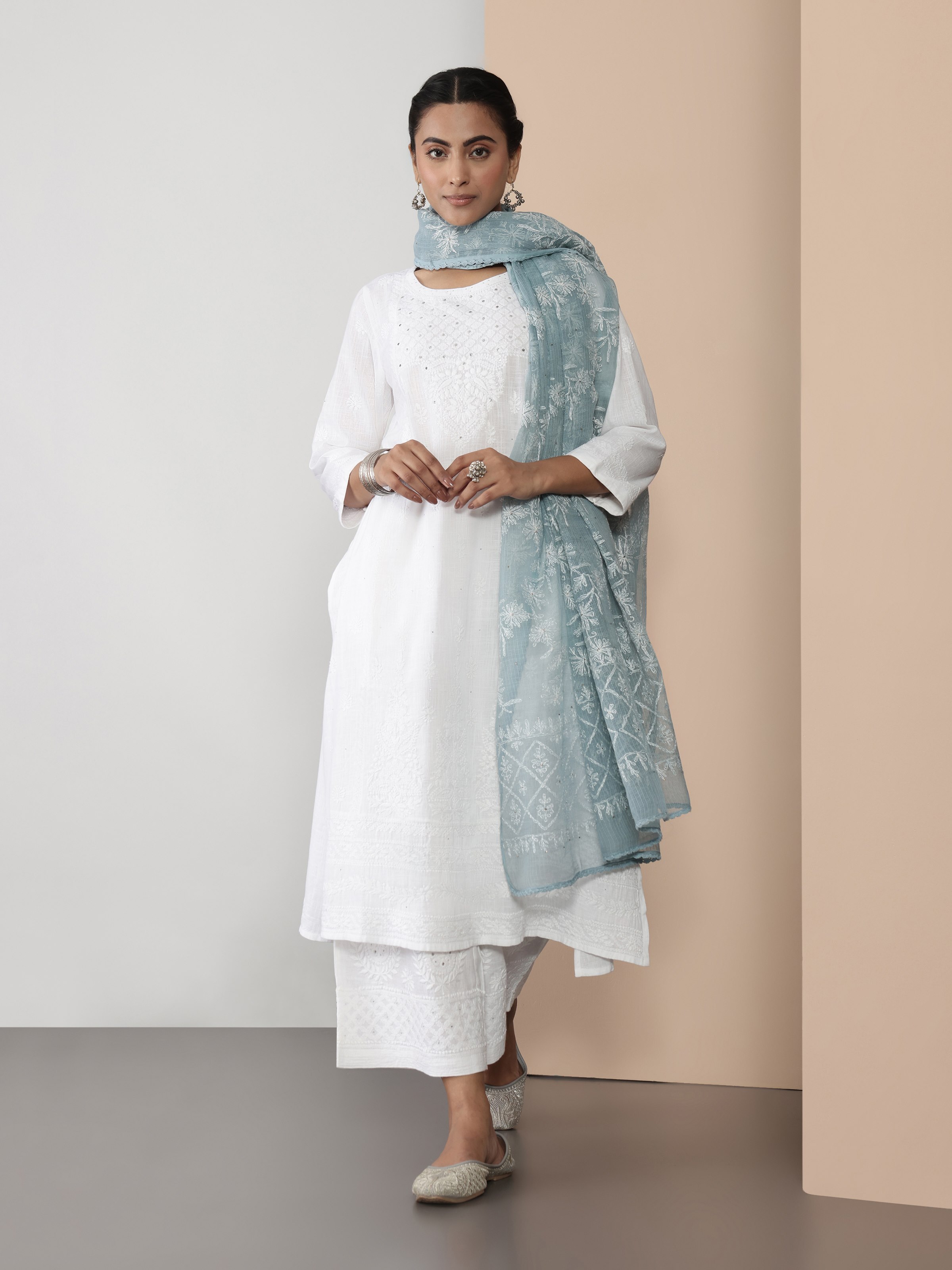 Woman pairing white palazzo with Chikankari kurta for a monochrome ethnic look.