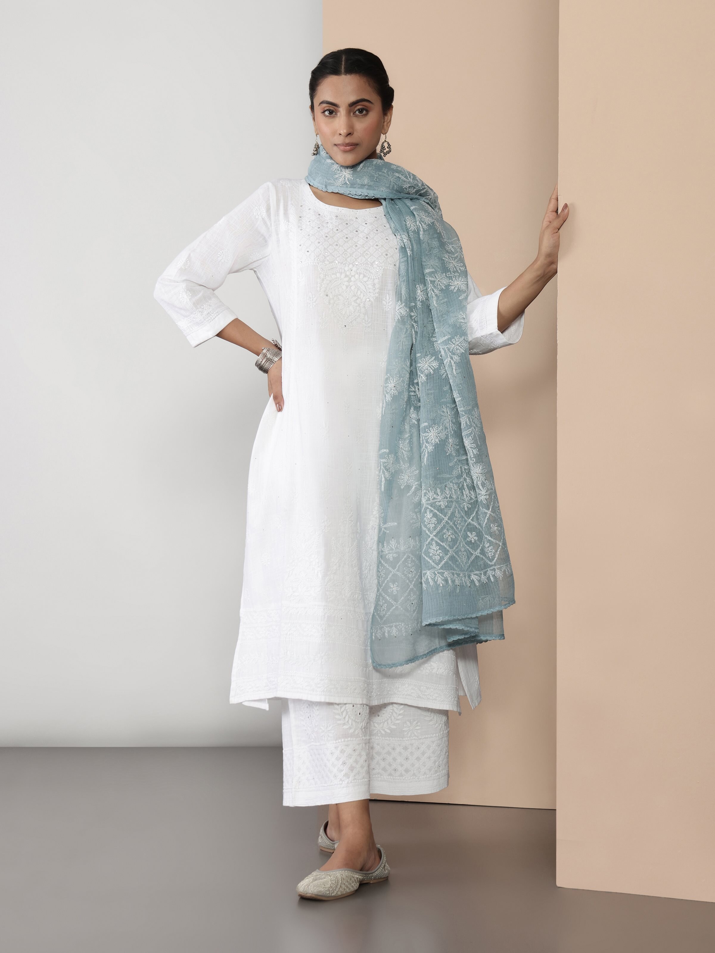 Side pose showing embroidery details and airy silhouette of palazzo pants.