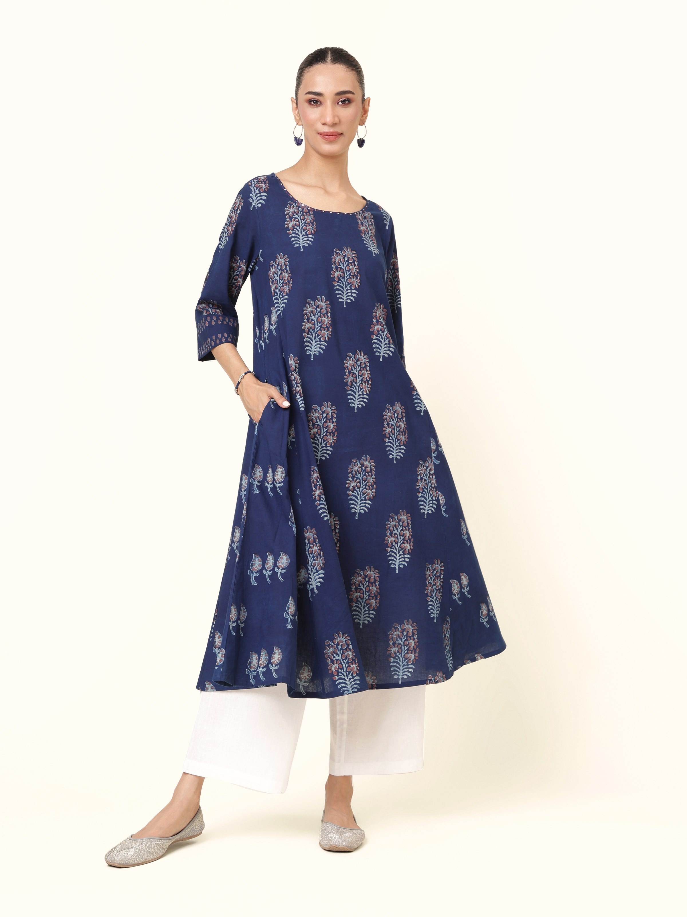 Front view of blue cotton Dabu block printed flared kurta with round neck and three-quarter sleeves