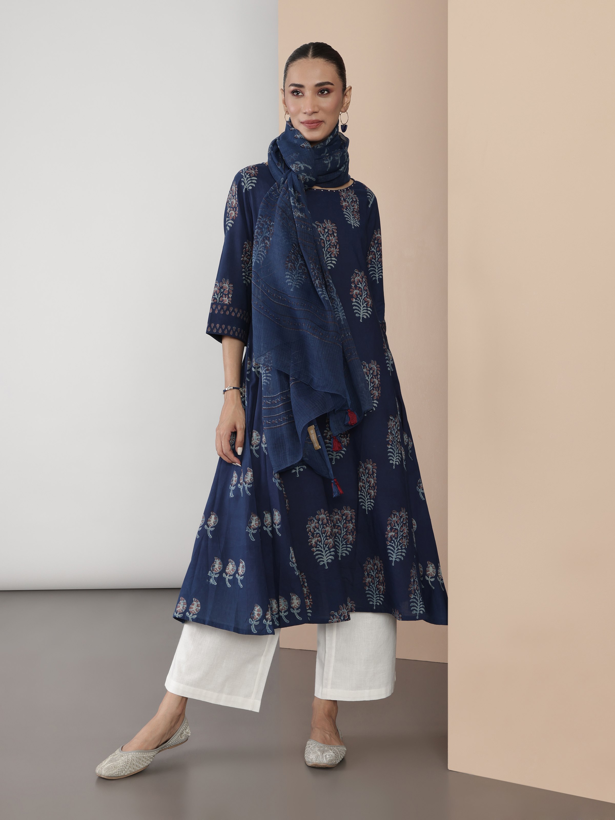 Lifestyle view of blue Dabu print flared cotton kurta styled with contrast bottoms